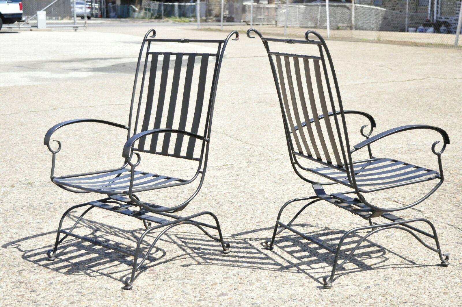 Hollywood Regency Style Black Wrought Iron Rock and Spring Garden Patio Chairs - a Pair. Item features heavy wrought iron and steel frames, rock and tilt spring scrolling base, very nice pair, quality craftsmanship, great style and form. Circa Late