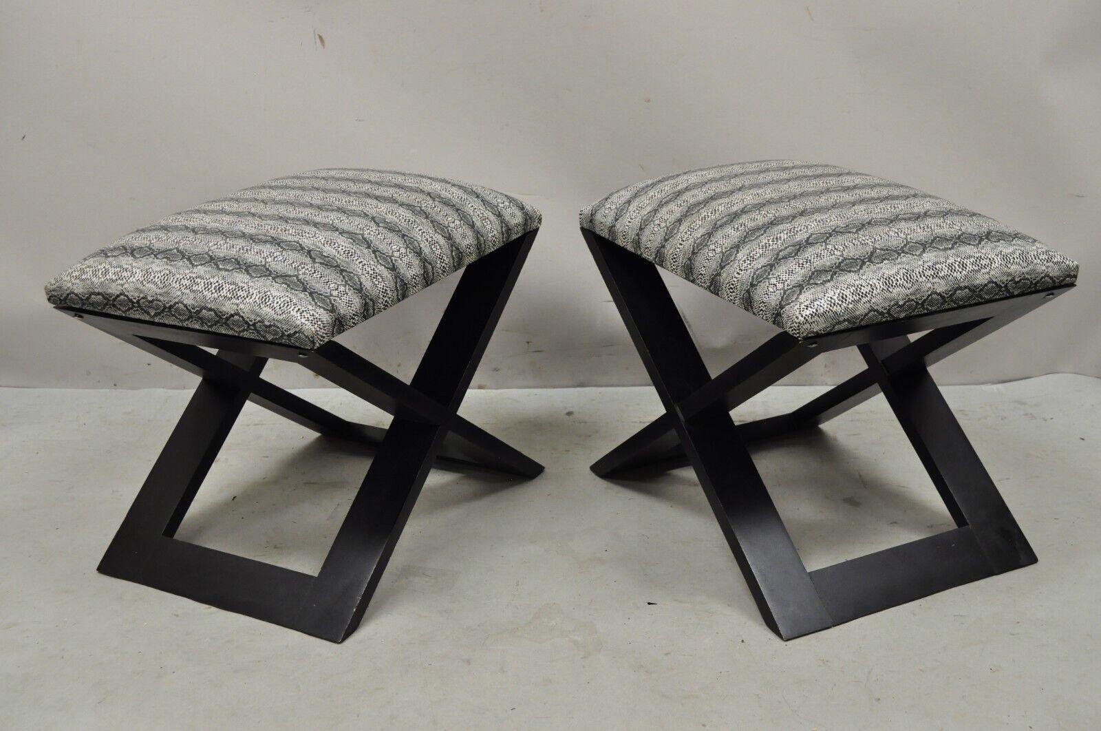 Hollywood Regency style black x-frame stools snakeskin upholstery - a pair. Item features black vinyl snakeskin upholstery, black painted finish, solid wood frame, clean modernist lines, great style and form. Circa late 20th to early 21st century.