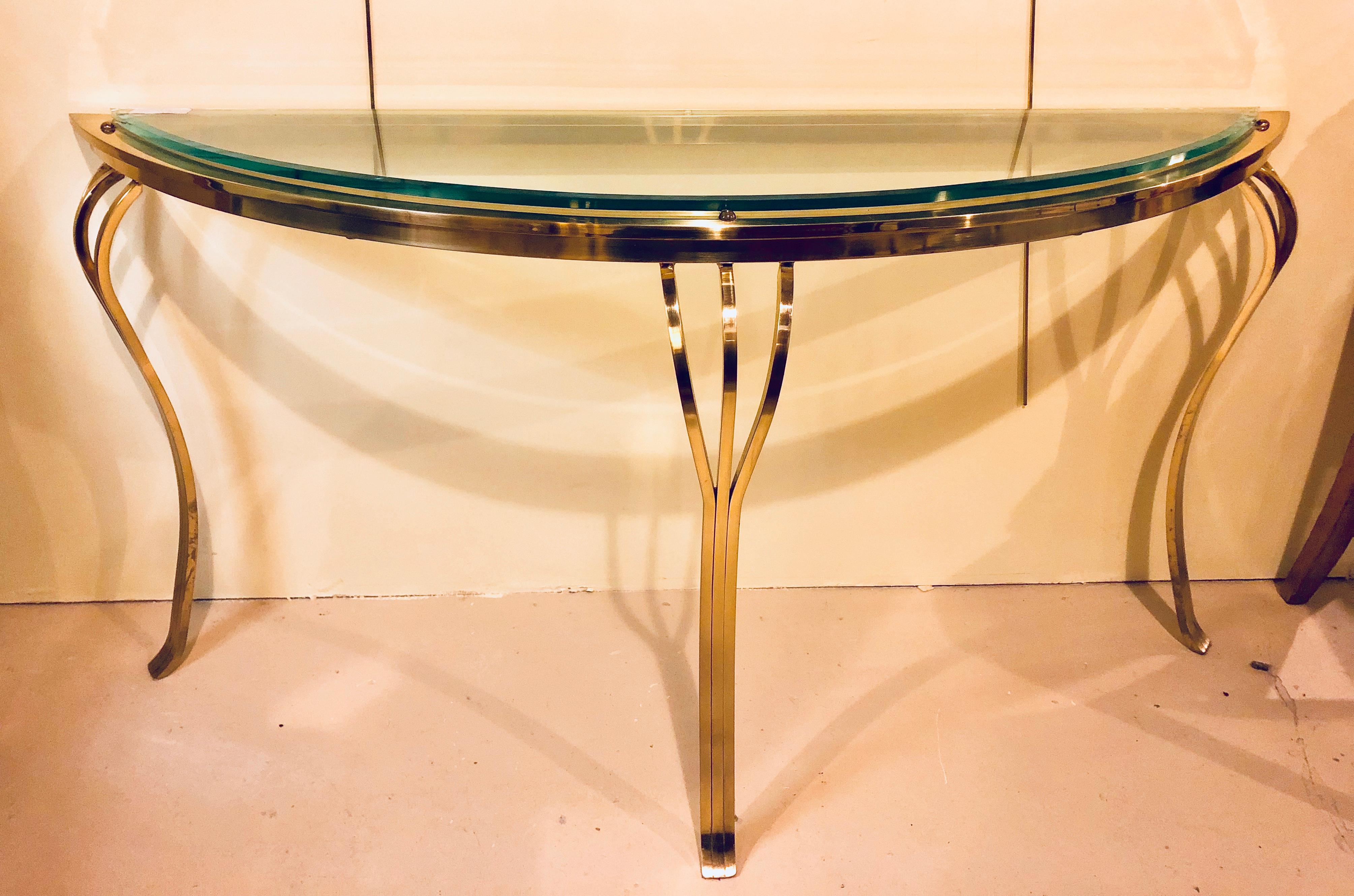 Hollywood Regency style brass and glass top demilune console table beveled glass having cabriole legs. This lovely console table has a 3/8 inch thick beveled glass top. There is a tiny chip on the edge of the glass, priced into consideration,