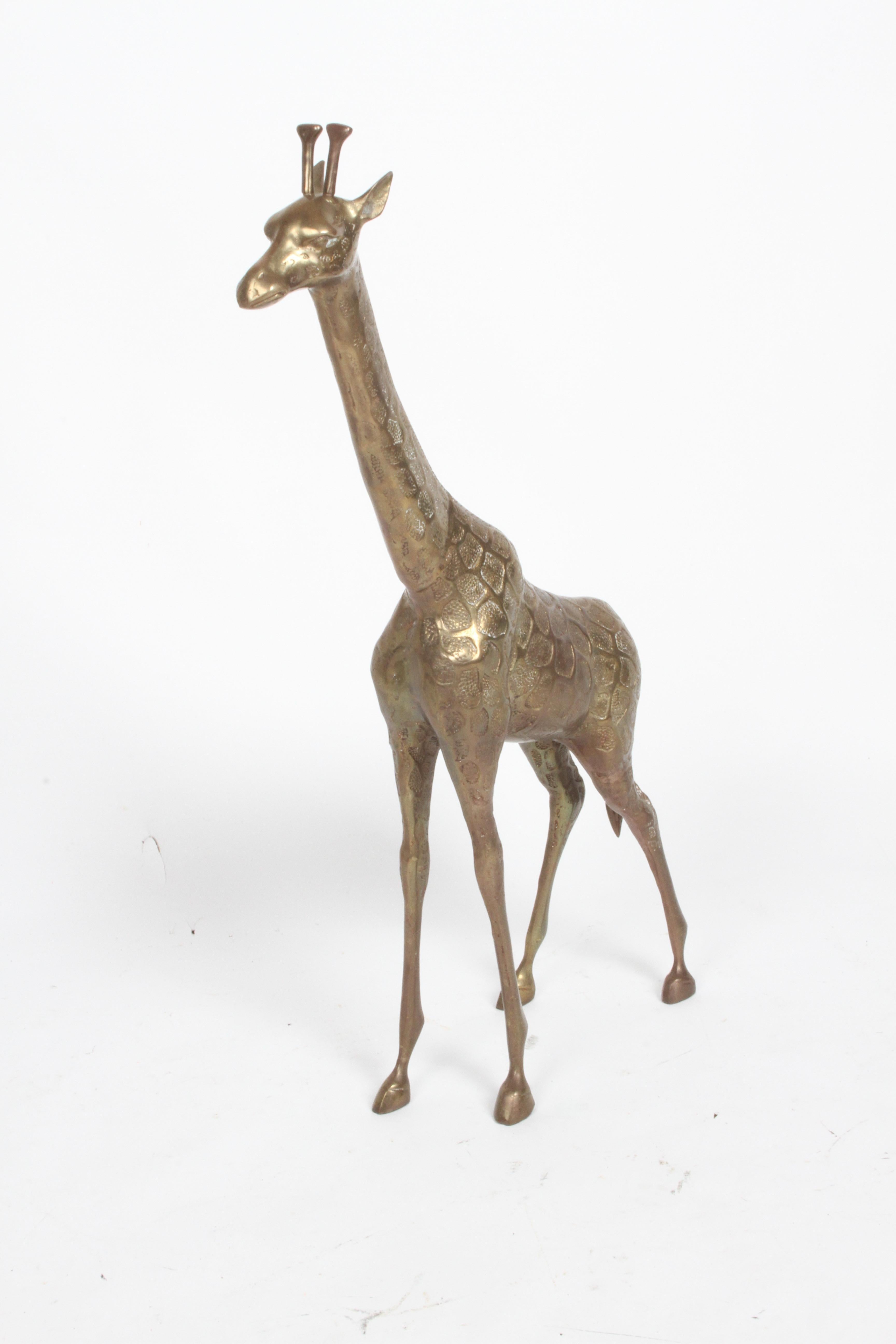 Vintage Hollywood Regency style standing brass Giraffe floor statue or sculpture circa 1970s. Original patina, unpolished. In fine condition, no damage noted.