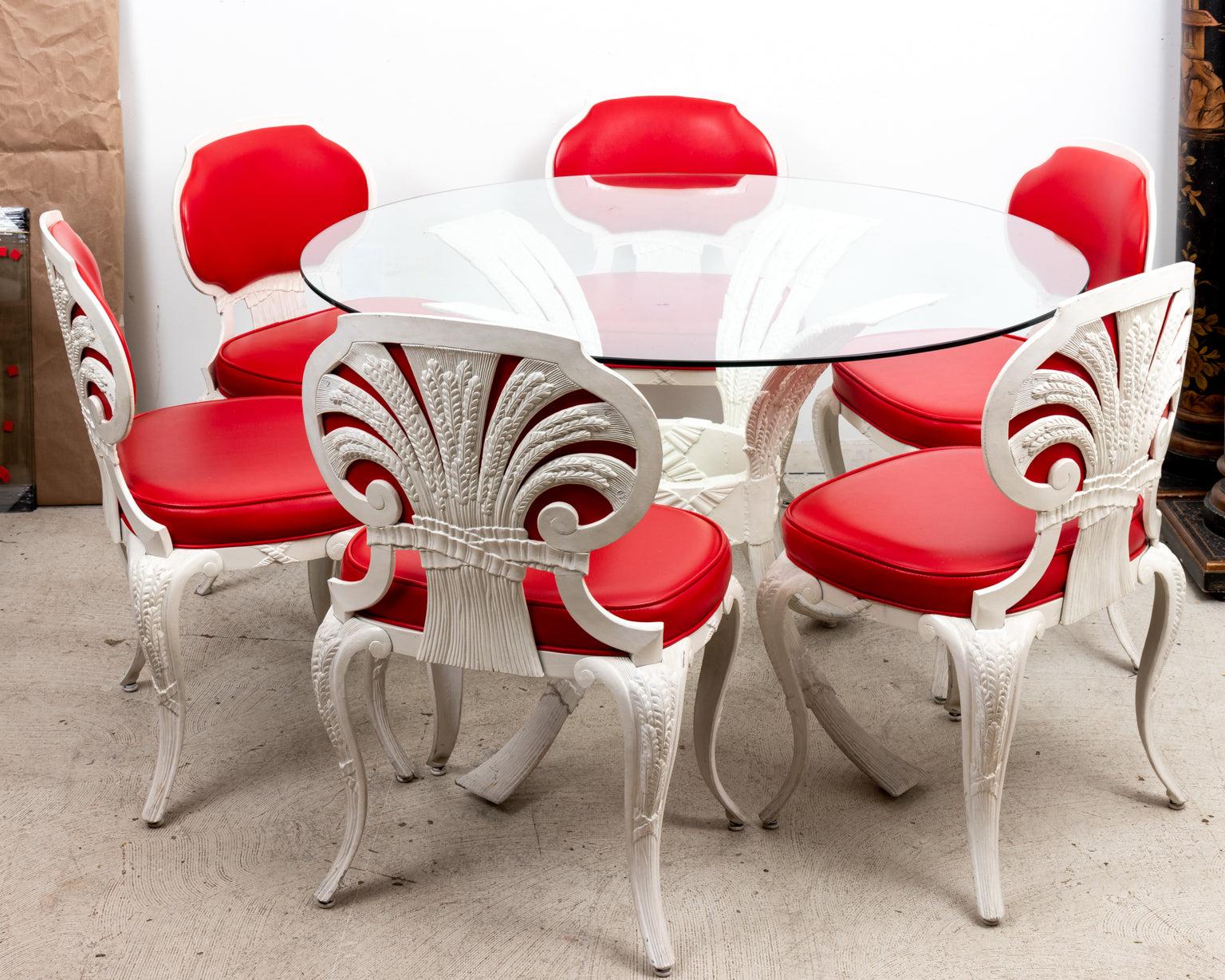 Hollywood Regency style round glass top table with set of six red upholstered chairs on cabriole legs. The table and chairs are constructed in white painted aluminum with ribbon motifs and bushels of wheat motifs as seen on the seat back of the