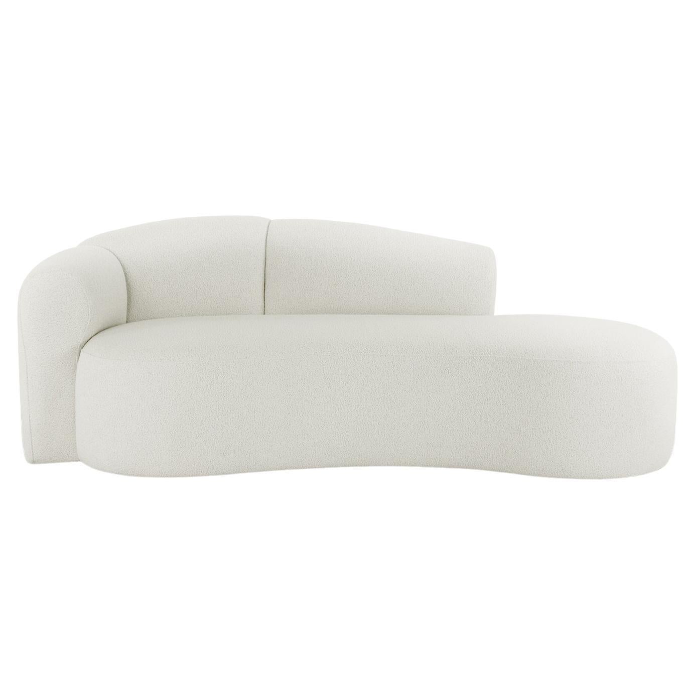 This striking and luxurious chaise longue is a beautiful blend of comfort and sculptural design. It features a graceful, upholstered curved form that invites you to recline in style. The chaise's most distinctive element is its backrest, which is