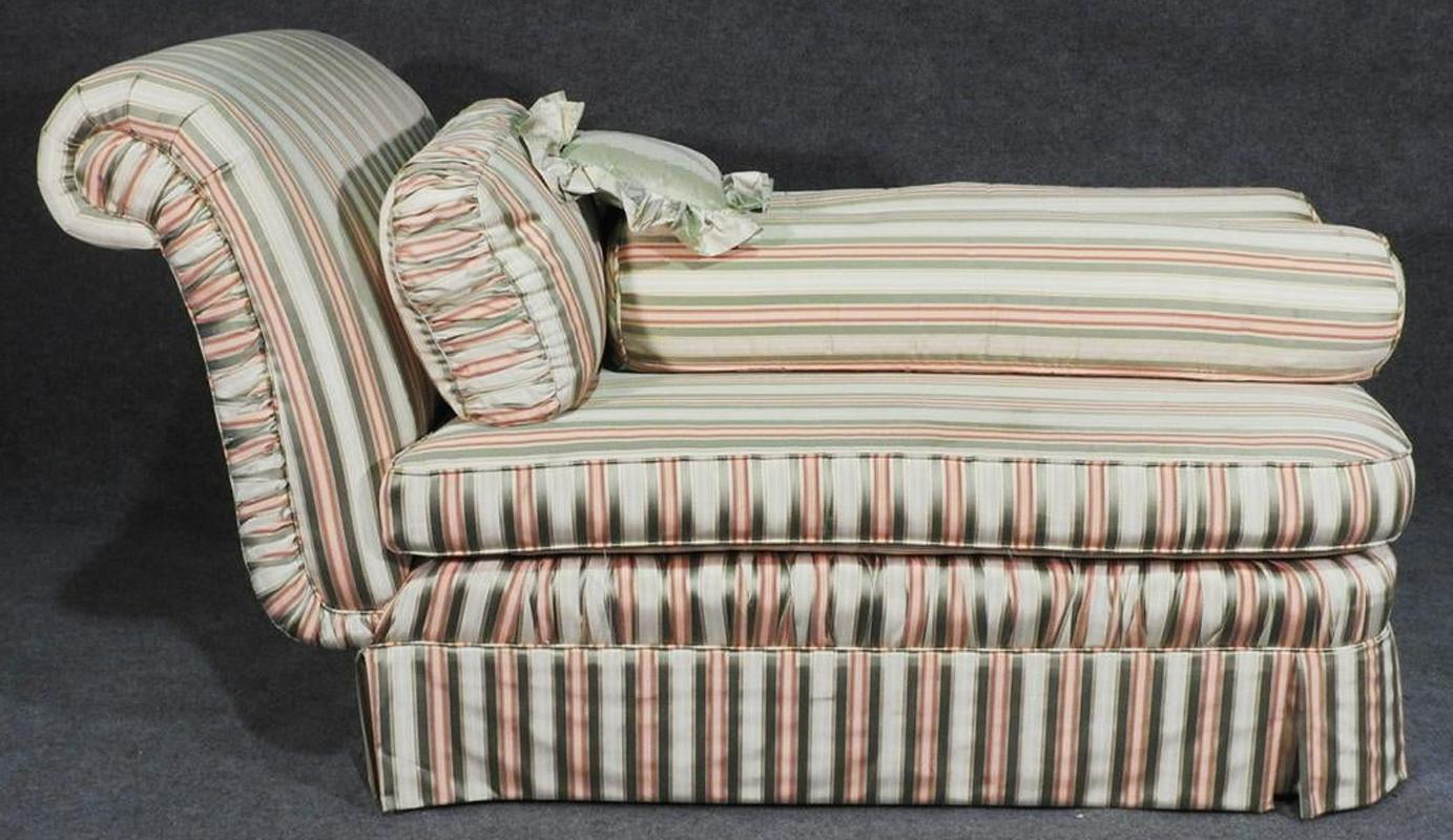 This is a nice daybed designed in the Hollywood Regency style. The daybed is very comfortable and can be reupholstered in any fabric you wish to completely transform the look and feel of this piece. It measures: 37
