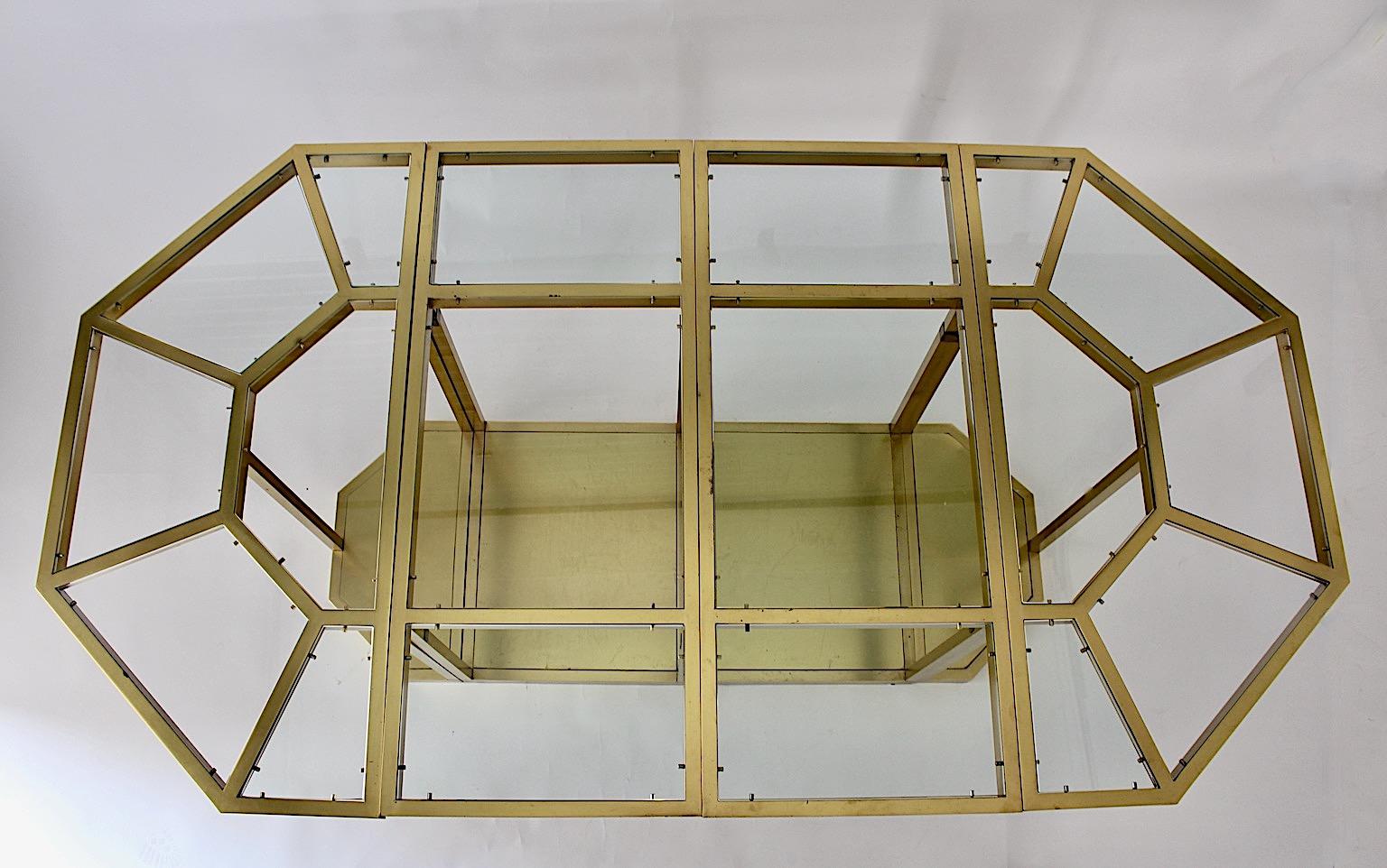 Modernist sculptural vintage dining table or consoles or center table from solid brass and clear glass designed 1970s Italy 
attributed to Gabriella Crespi.
This outstanding and sophisticated dining table from solid brass and clear glass inlays is