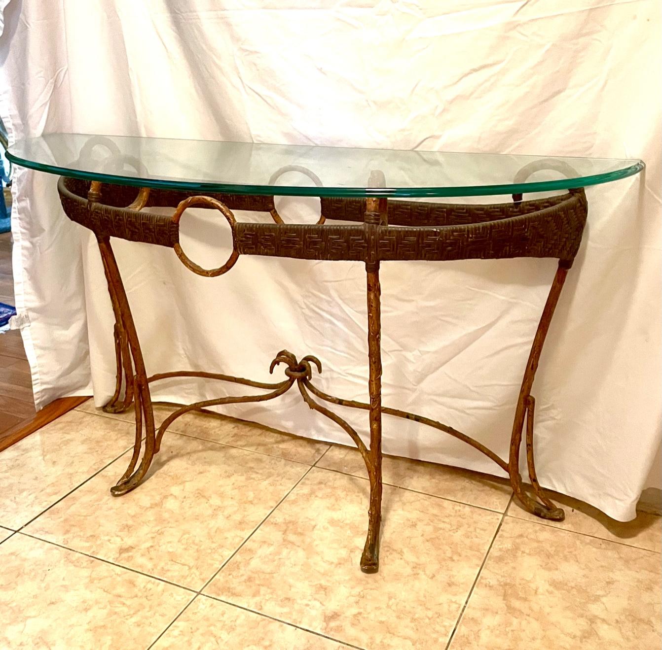 Hollywood Regency style faux bamboo iron rattan glass demi lune console table.

This stunning demi lune console table is stylishly created with circular rattan banding in iron with faux bamboo finish. It’s demi lune shape supports a considerable