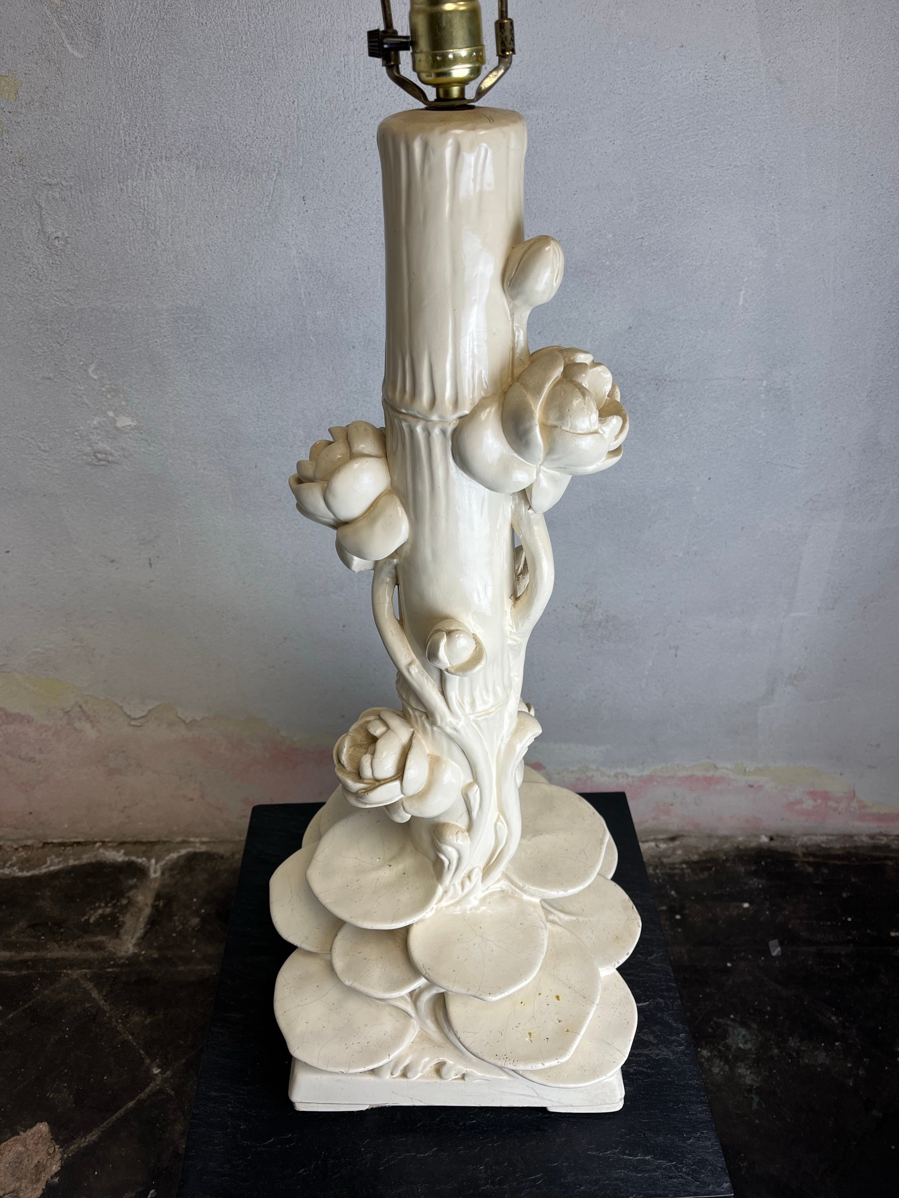 Hollywood Regency Chinoiserie style faux bamboo and lotus flower table lamp with lily pad base. This sculptural heavy weight plaster/chalk-ware lamp features a matte white plaster-like finish. Style of Serge Roche. Lamp shade not included.

Height