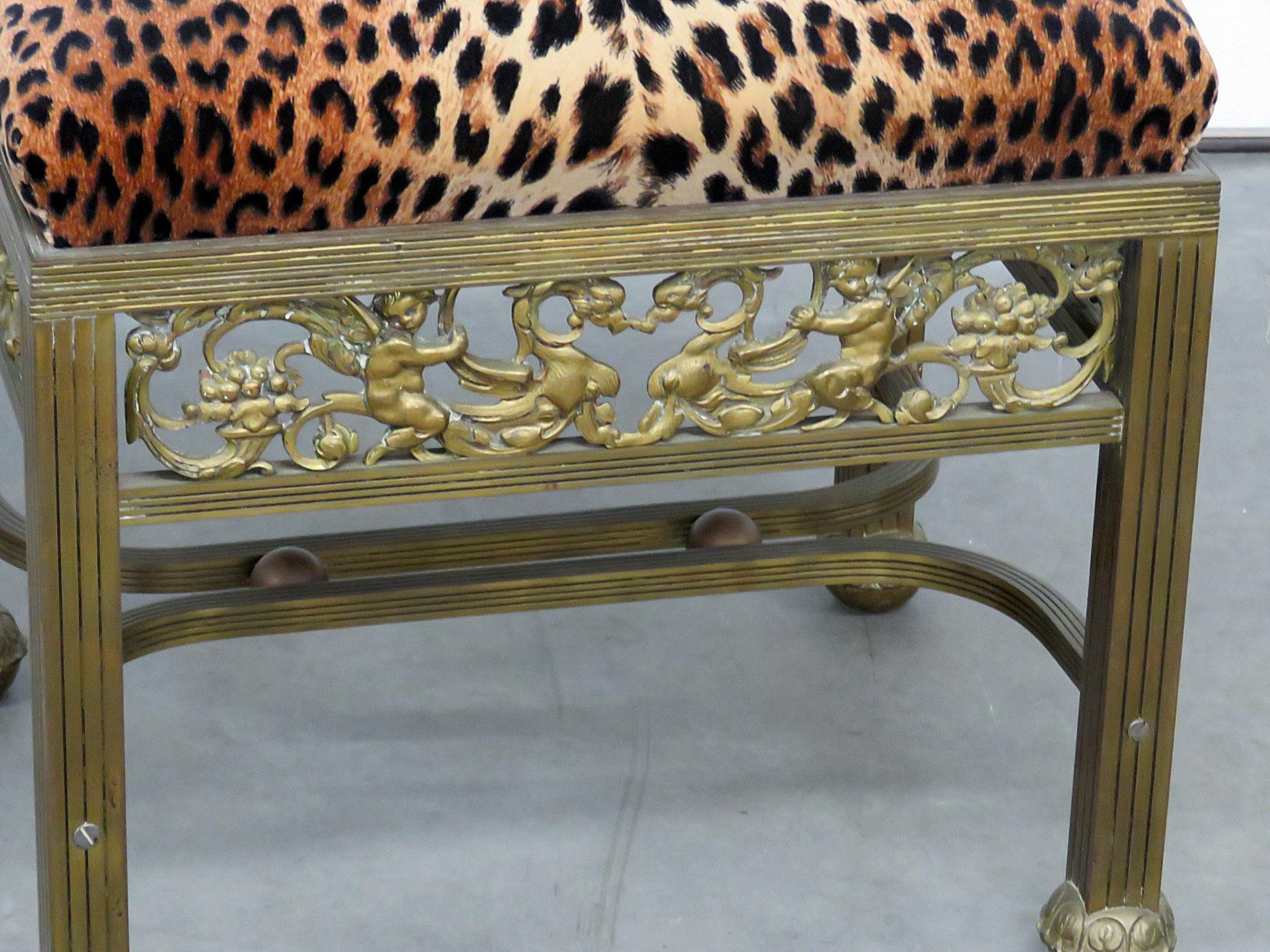 This is a gorgeous French Regency style brass foot stool with leopard print upholstery.