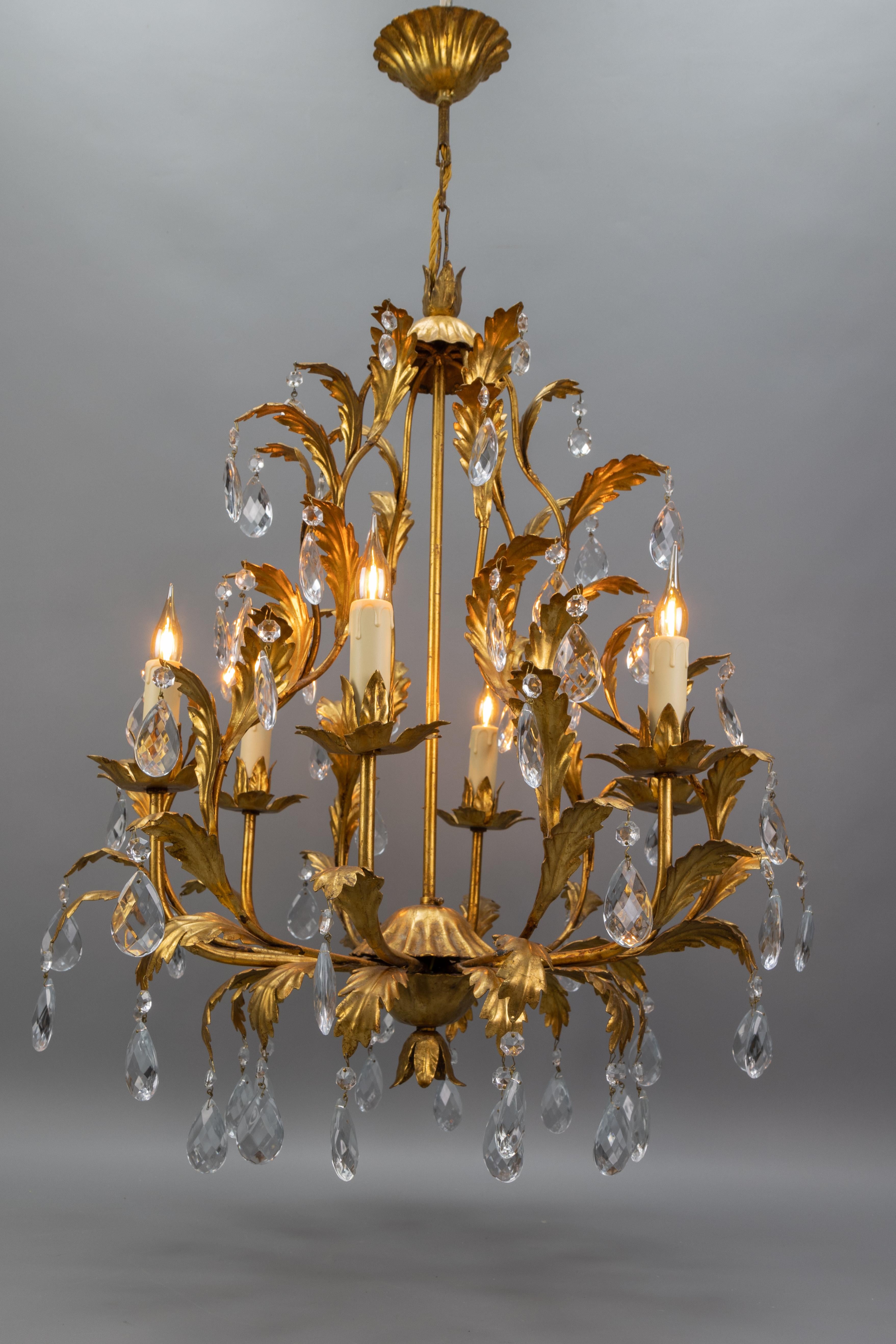 Glamorous 1970s Italian Hollywood Regency chandelier in gilt metal with sparkling crystal glass drops. Six lights, recently rewired, perfect for adding vintage elegance to any room.

Elegant Hollywood Regency–style chandelier made in Italy circa