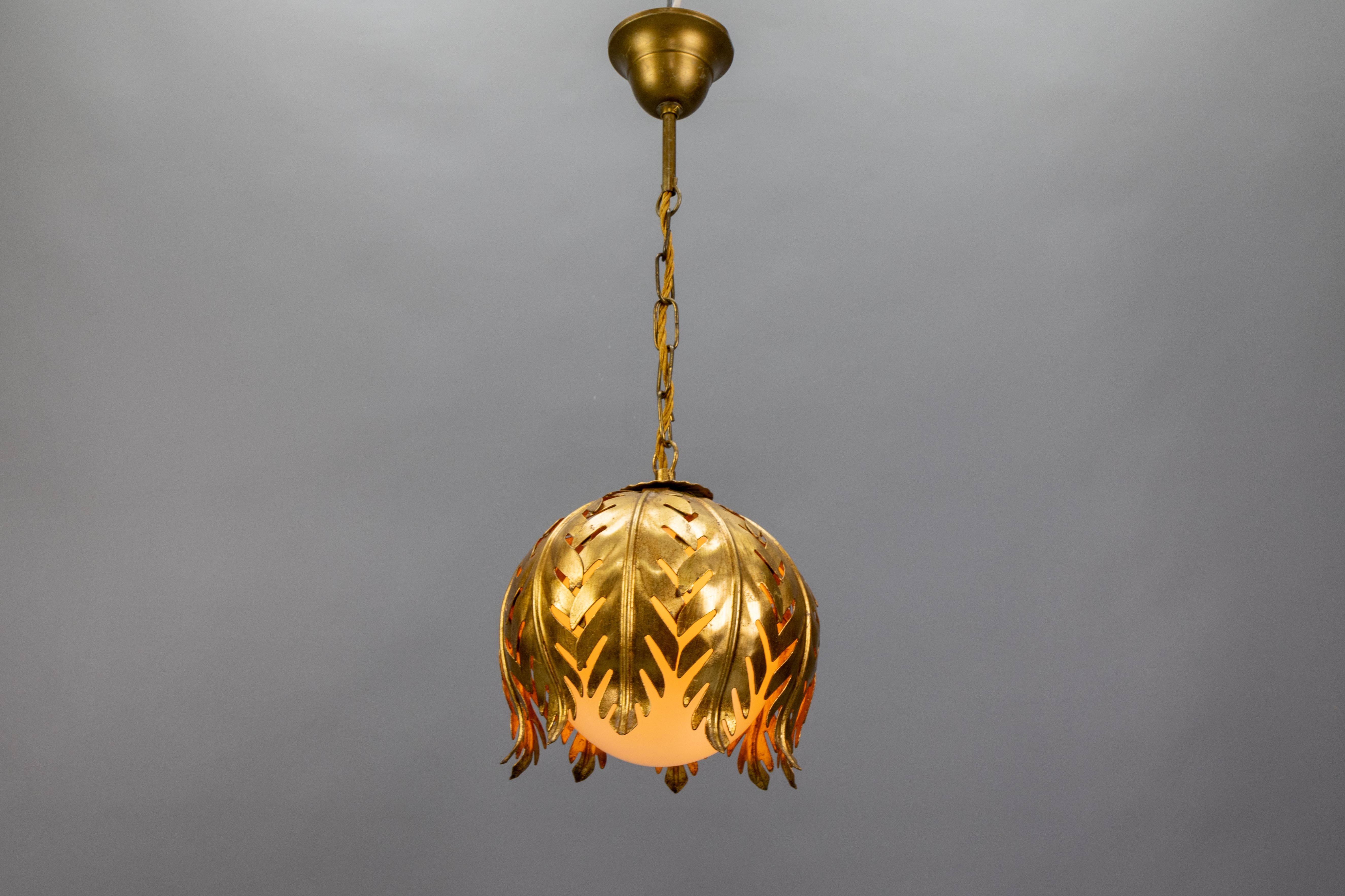 Hollywood Regency Style Gilt Metal and White Glass Floral Leaf Pendant Light by Hans Kögl, 1960s.

A beautiful Hollywood Regency-style pendant light, designed by Hans Kögl, Germany, circa the 1960s. This charming piece features a gilt metal floral