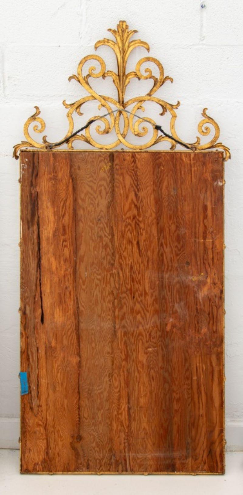 Hollywood Regency style wall mirror in gilt metal with scrollwork crest,  60