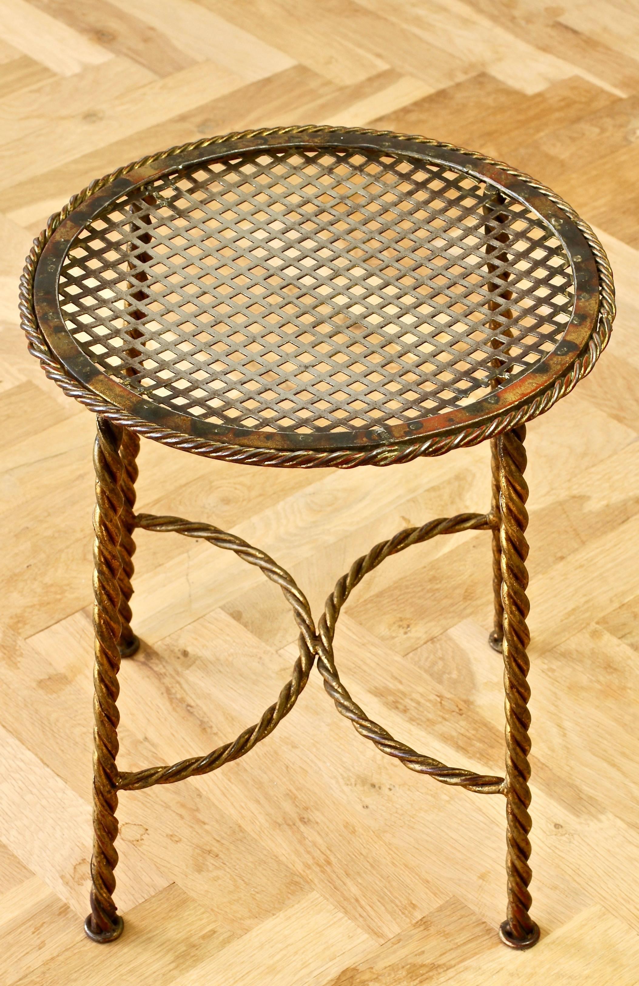 A beautiful midcentury handmade 1950s French or Italian made gold gilded wrought iron vanity stool or bench with rope and tassle details. Perfect for any Hollywood Regency lovers.

Would also make a great plant pot stand or side table.