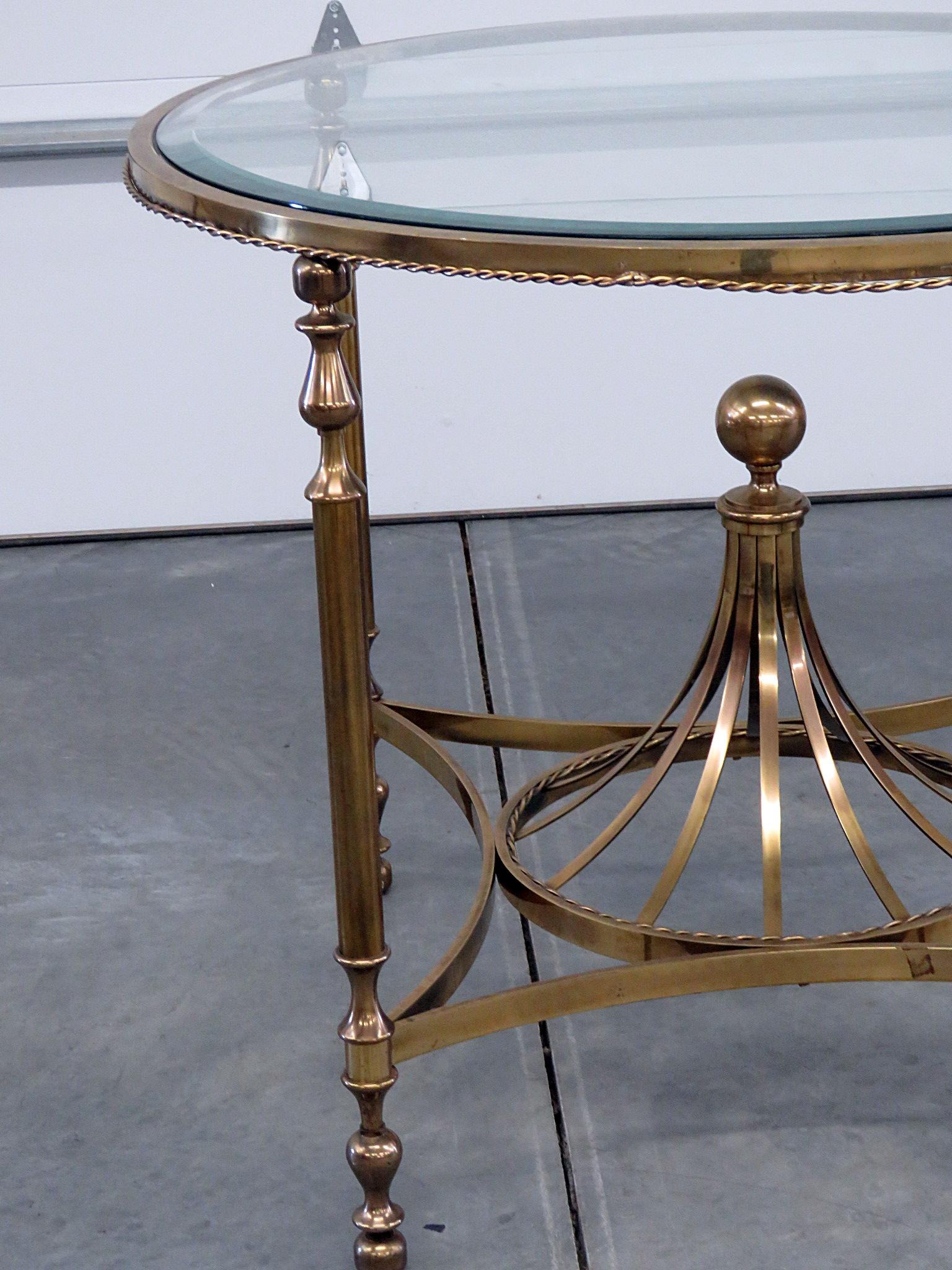 Hollywood Regency style beveled glass top center table with a gold colored metal base.