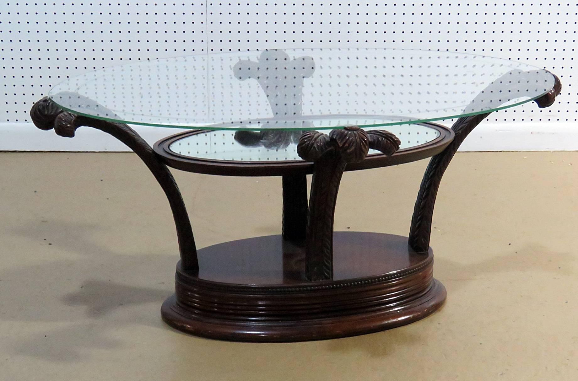 Hollywood Regency style glass top coffee table with Prince of Wales feathers style base.