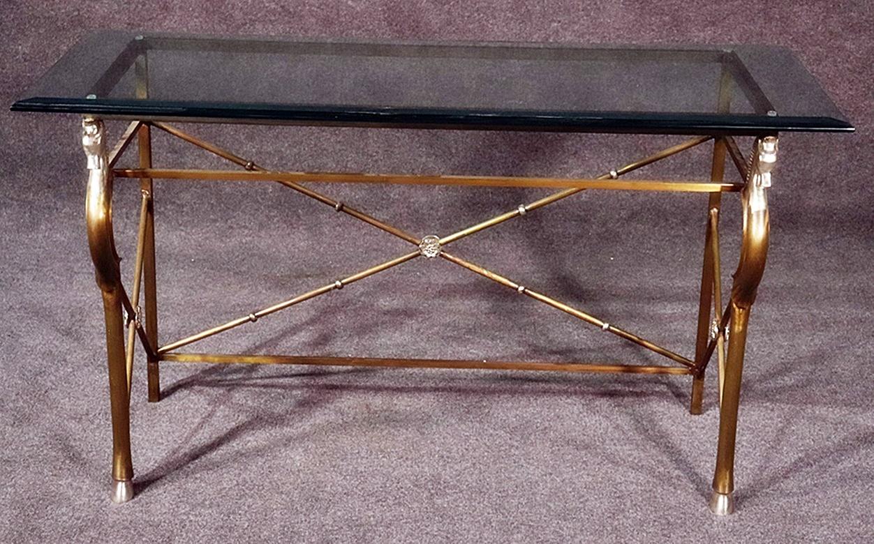 Attributed to Maison Charles of Paris. Hollywood Regency style brass and steel horse head console table with a beveled glass top.