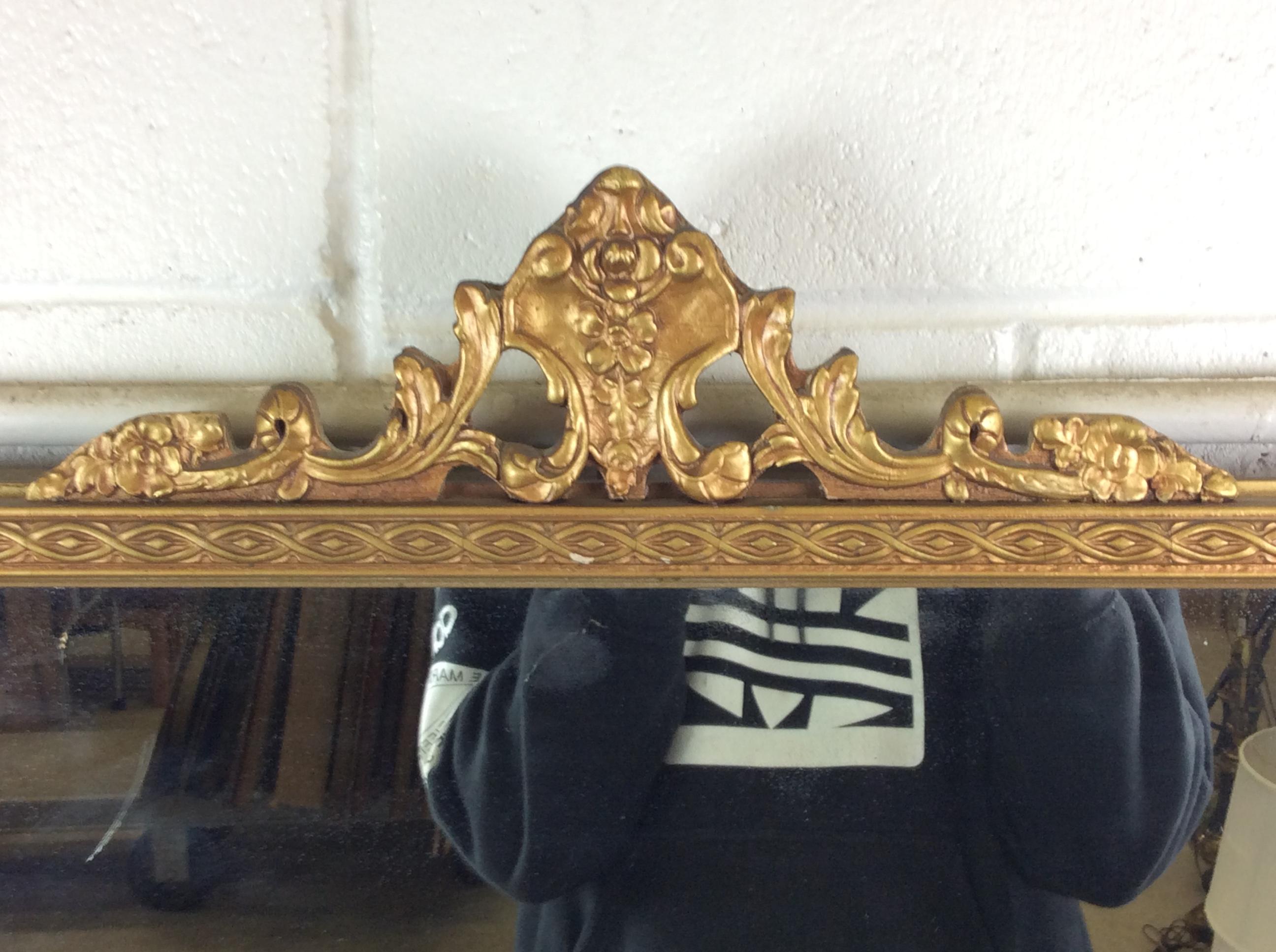 Hollywood Regency style rectangular gold wood framed wall mirror. Nicely accented wall mirror in excellent condition. Hardware is included. No marks.