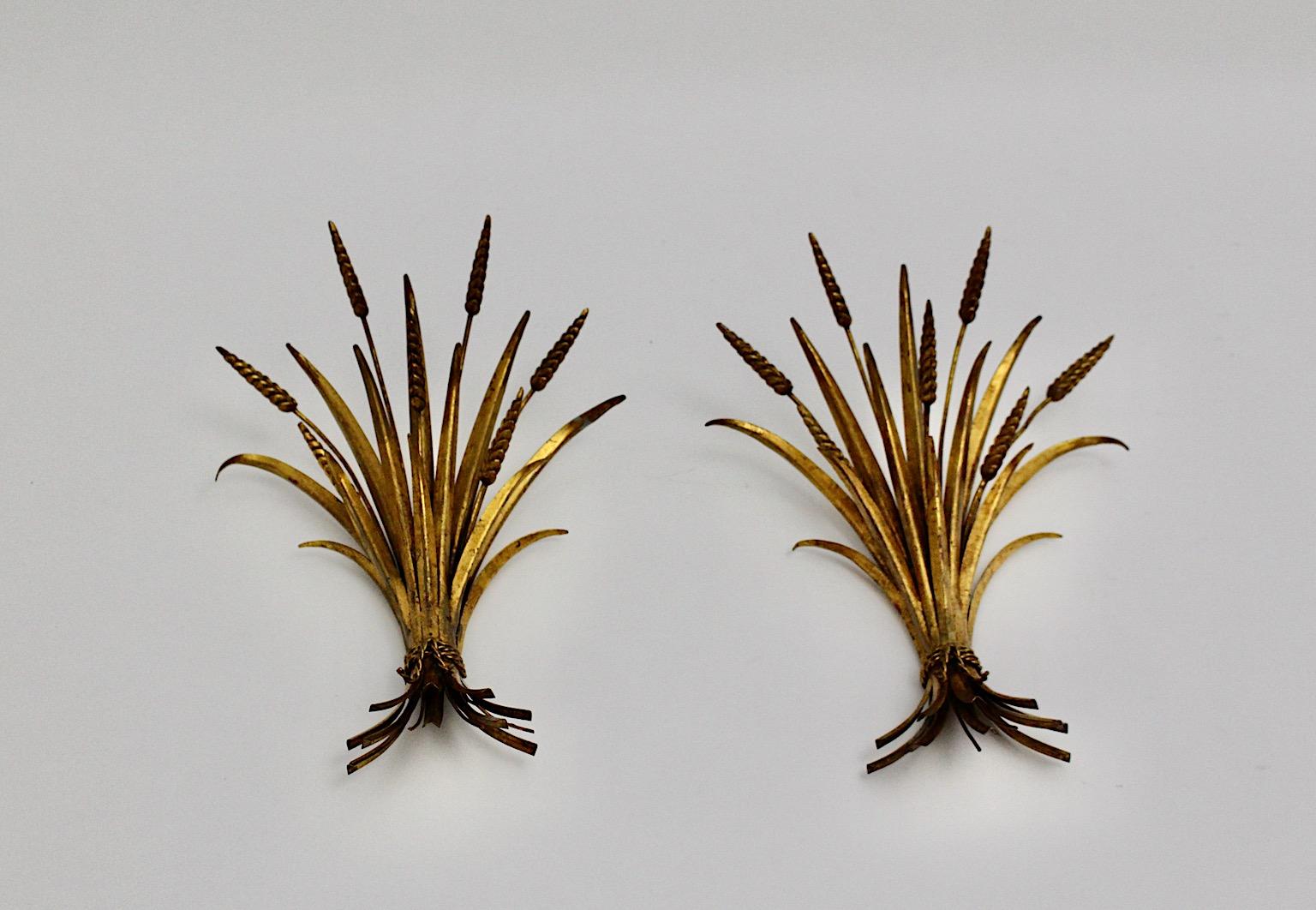 Hollywood Regency Style vintage pair of sheaf of wheat wheat appliques or sconces from gilt metal 1970s France.
Wonderful elegant wall mounted pair of appliques or sconces sheaf of wheat like worked in warm golden tone. 
It is nice to know that