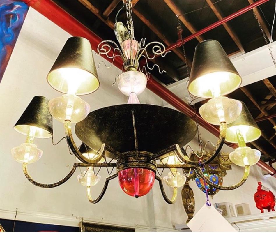 A Hollywood Regency style iron and Lucite with colored glass chandelier
This finely decorator designed chandelier is simply stunning in its rustic metal and gilt design frame with Lucite mounts and colored glass. The whole having matching shades.