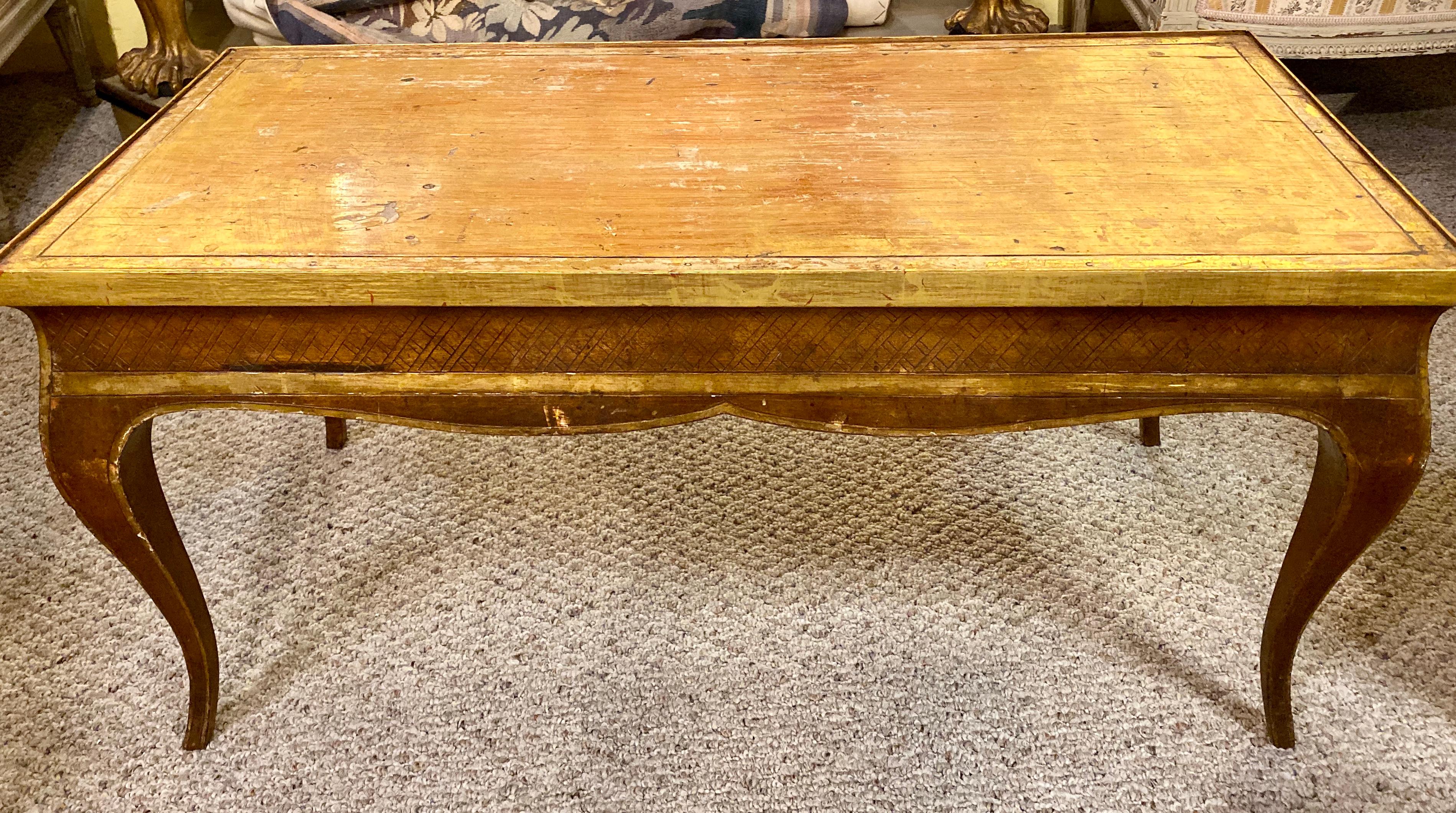 Hollywood Regency style Jansen gilt gold coffee table. The Louis XV Style Coffee Table having all around gilt design with decorative X design. With Brass side pulls. 