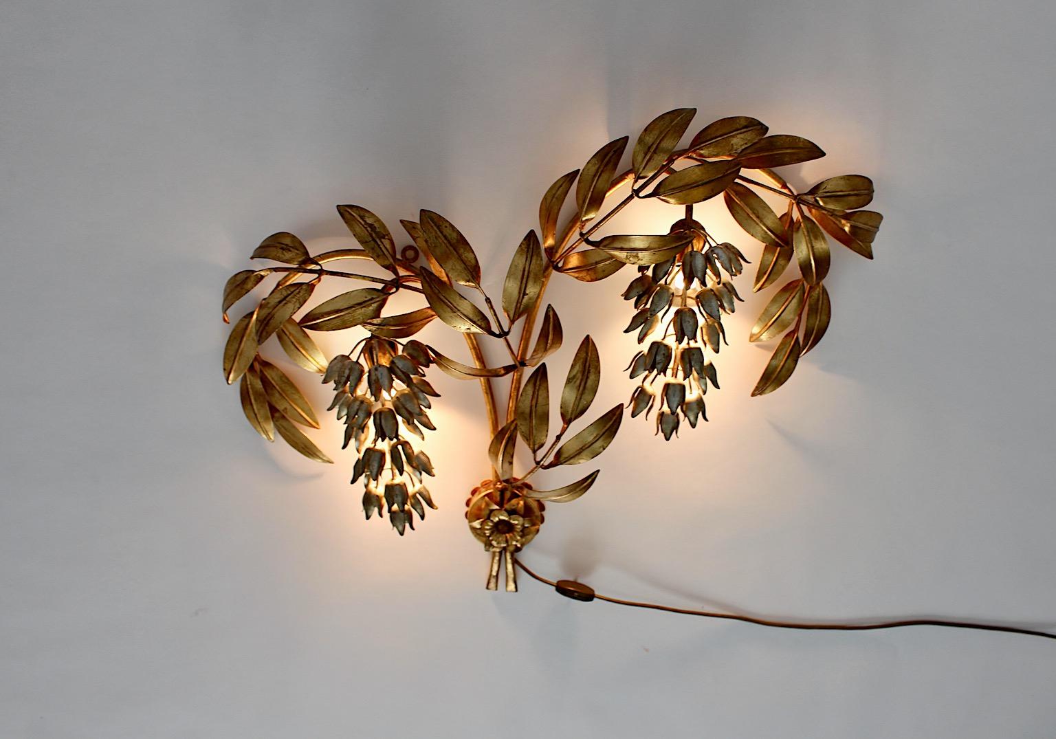 Hollywood Regency style vintage wall light sconce from gilt silver gold metal in flowers and leaves shape designed by Hans Kögl Germany 1970s.
The elegant and very beautiful wall light shows golden leaves and silver flower blossoms in high quality,