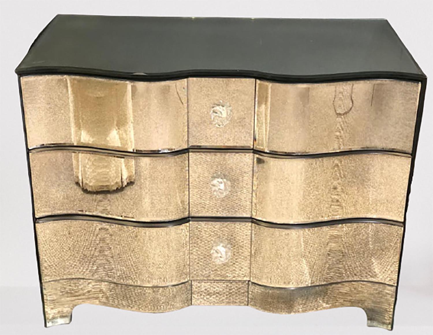 Hollywood Regency style mirrored chest, dresser, nightstand by Lorin Marsh. This sleek and stylish Lorin Marsh Design Regency style mirrored dresser sports a fine serpentine front with crystal pulls having an all around antiqued mirrored glass. This