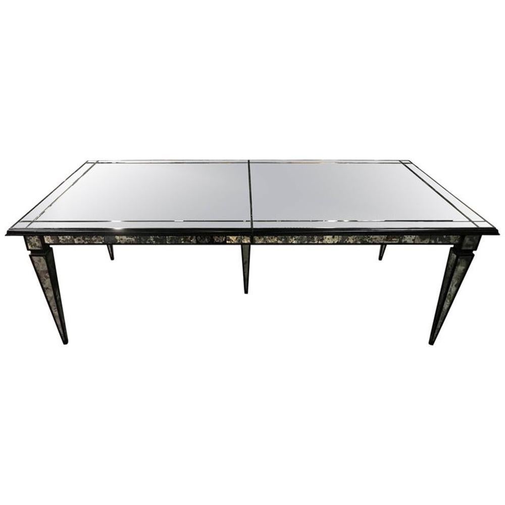 Hollywood Regency style mirrored dining room or center table. This finely constructed dining or center table has all mirrored glass surround with tapering legs supporting the table top of mirrored design. The wooded table itself having an ebony