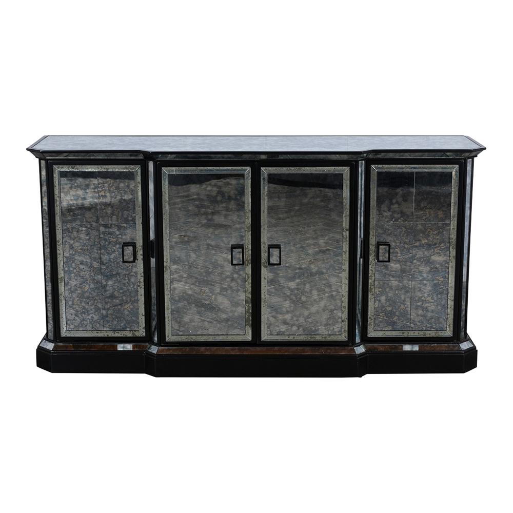 This Hollywood Regency style mirrored sideboard has large mirror top. The piece has mirrored panels adorning the sides, doors, edges and a new ebonized and lacquered finish. It also features four large drawers, inside the left door there is a drawer