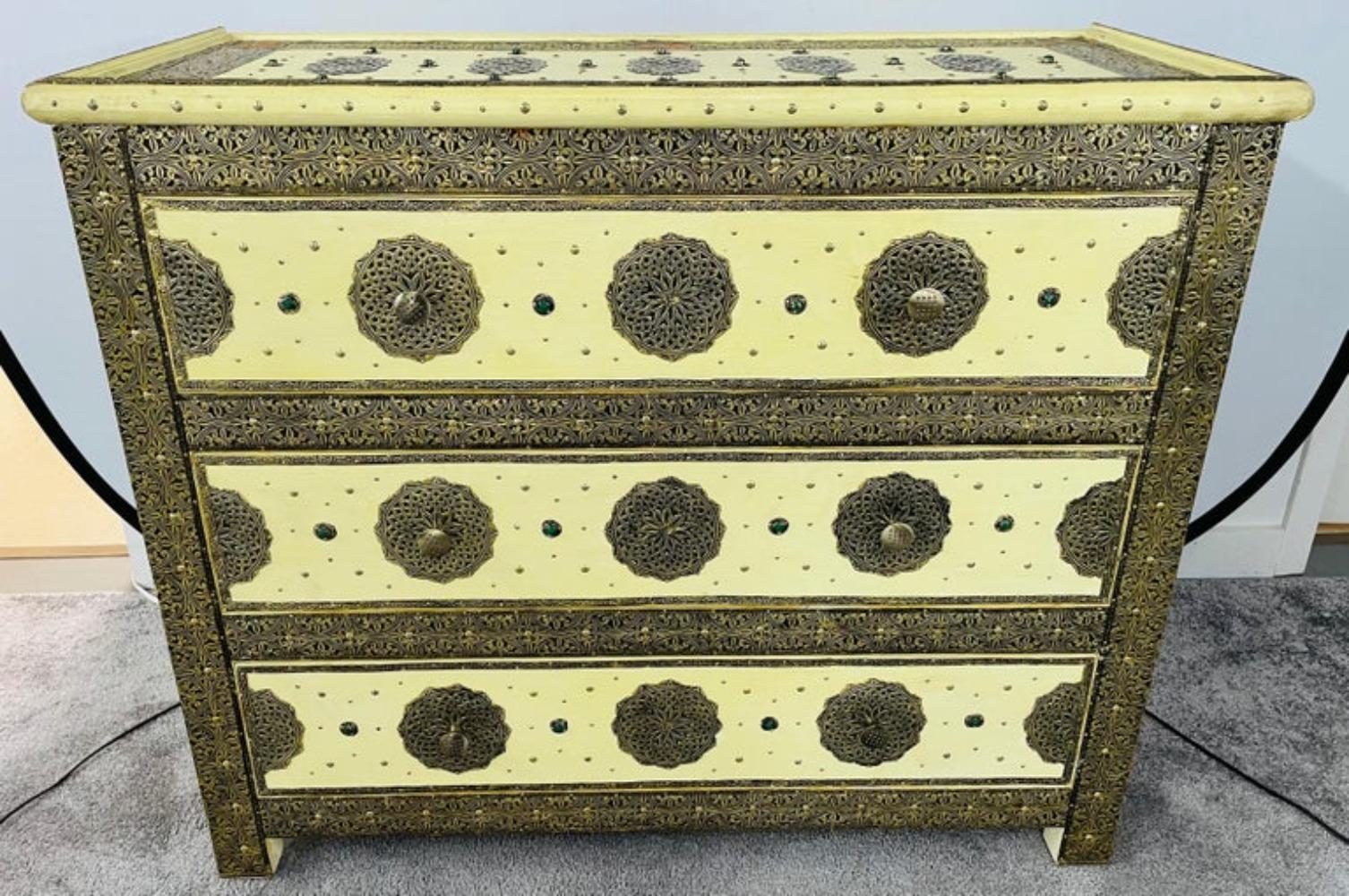 An opulent Hollywood regency style commode, chest or nightstand. This exceptional chest depicts and compliments the Hollywood Regency era at its finest. The commode features amazing intricate latticework on silver-toned metal and brass and ornate