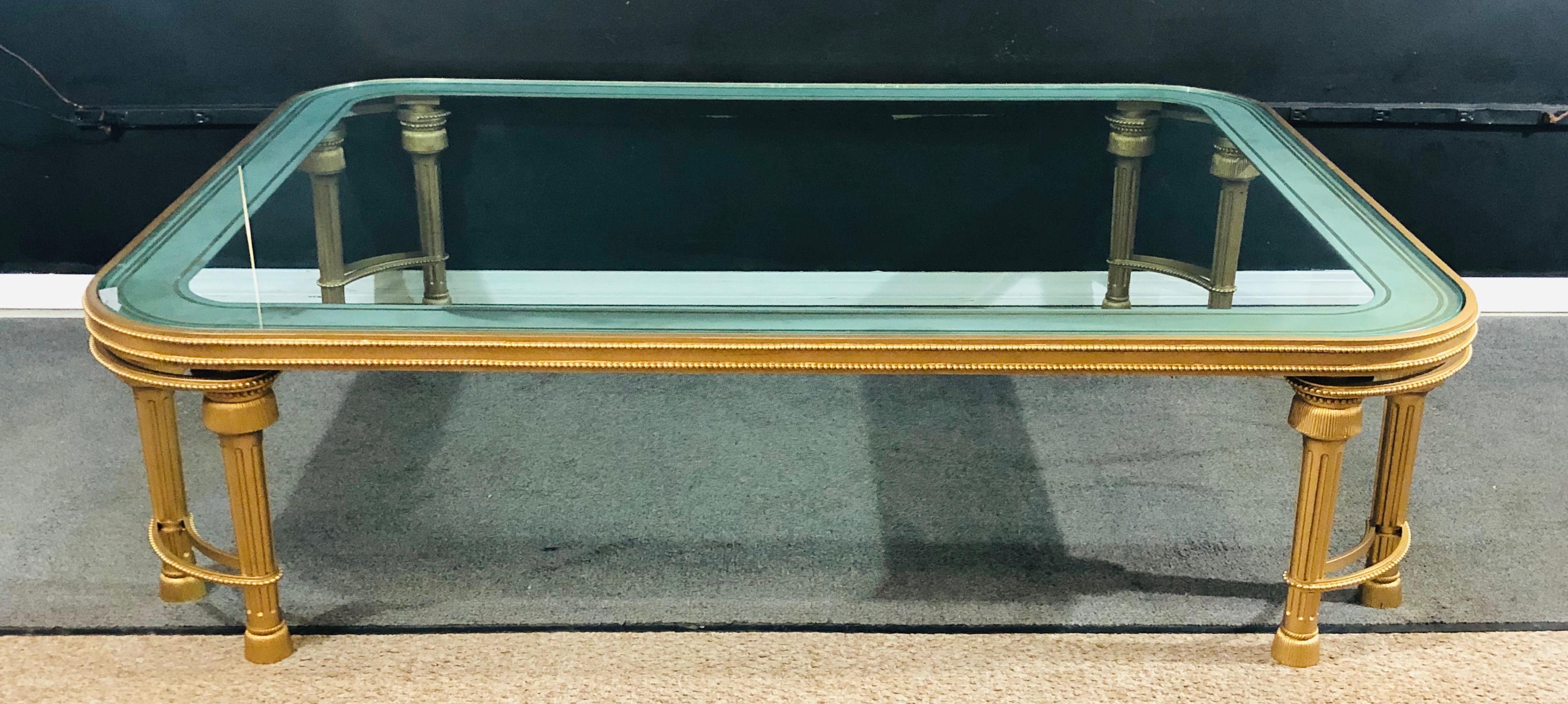 Hollywood Regency style P.E. Guerin coffee table with etched frosted glass sitting on a solid bronze Louis XVI style base. This finely crafted 20th century coffee or low table has an almost square form with a frosted etched banded glass top,