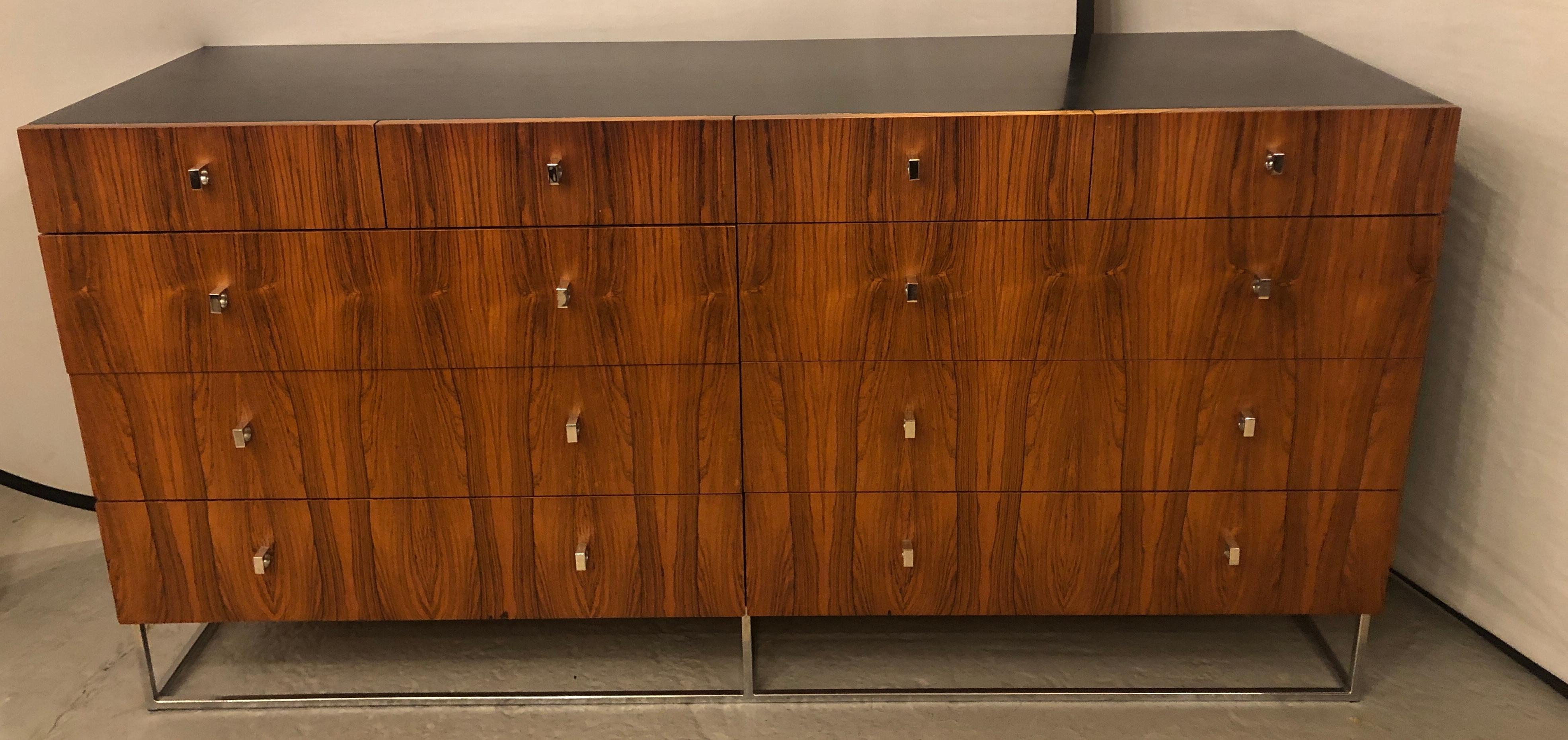Hollywood Regency style Rougier rosewood and black lacquer credenza chest, dresser or serving cabinet sitting on a chrome base with chrome drawer pulls. The whole having four upper drawers over six larger drawers. Plenty of storage on this fine and