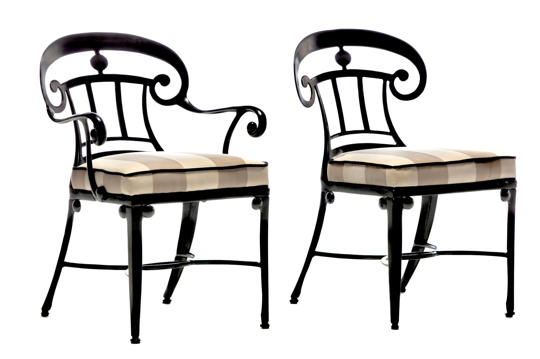 Set of 10 Hollywood Regency style indoor outdoor dining chairs fully restored from top to bottom with black cast aluminum frames and contrasting sand and ivory awning stripe upholstery. From Palm Springs to Palm Beach, these incredibly elegant and