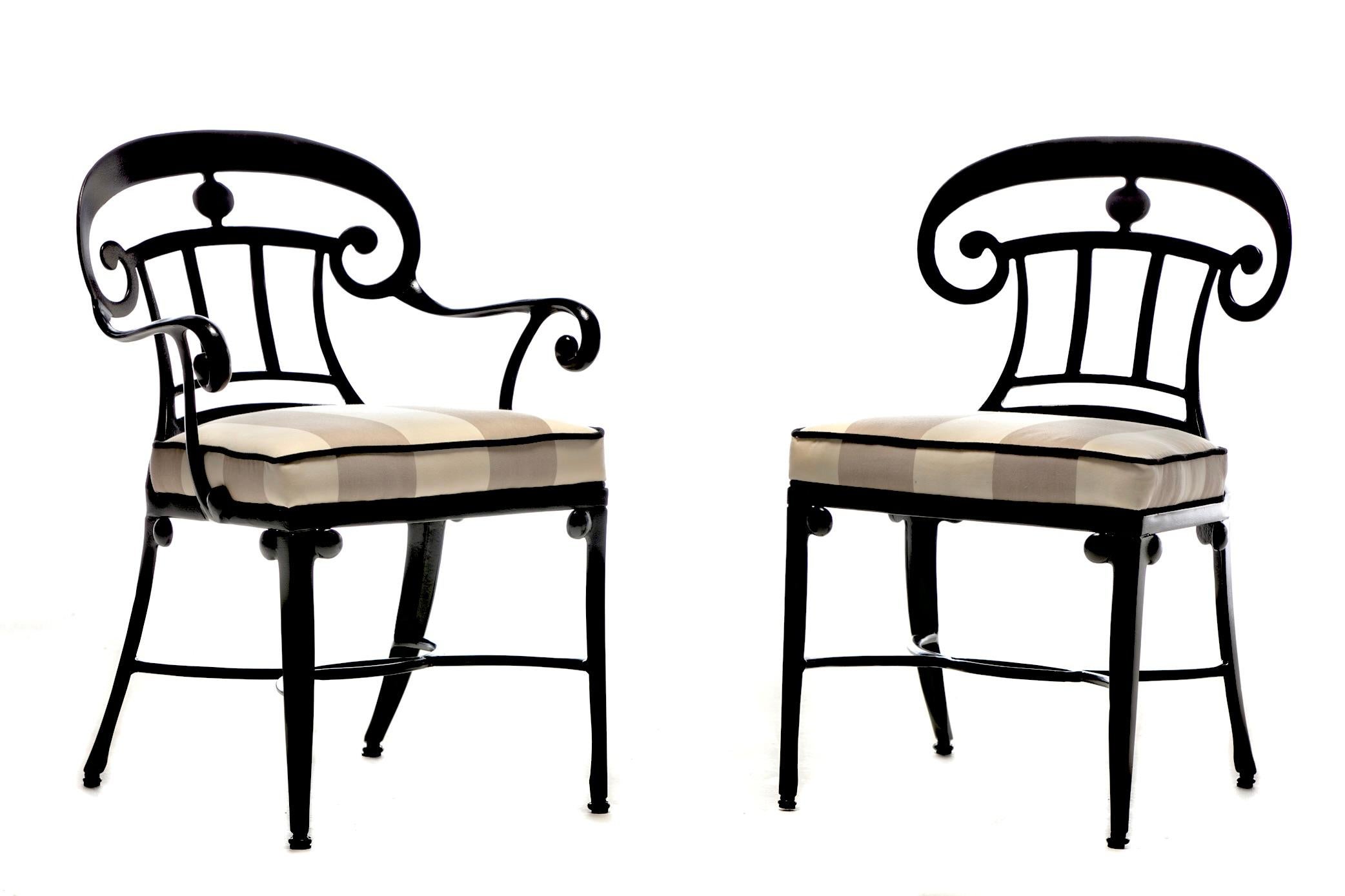 Set of 8 Hollywood Regency style indoor outdoor dining chairs fully restored from top to bottom with black cast aluminum frames and contrasting sand and ivory awning stripe upholstery. From Palm Springs to Palm Beach, these incredibly elegant and