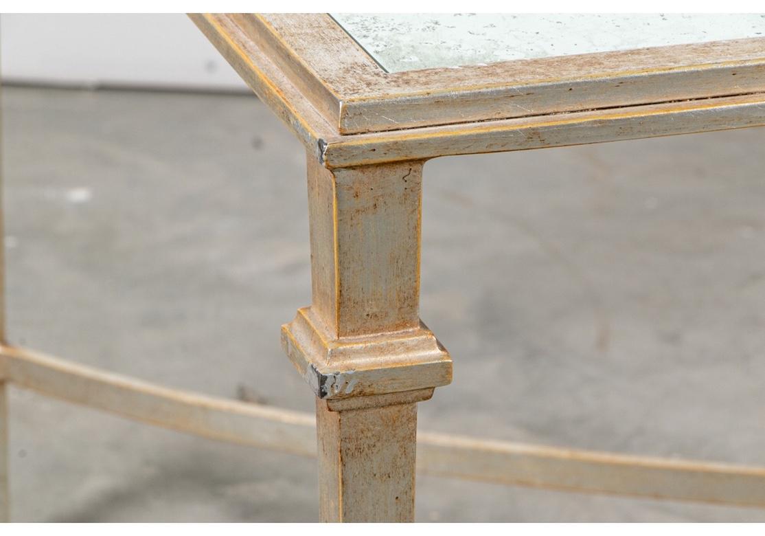 Une grande table basse rectangulaire de très bonne facture avec des pieds carrés effilés reliés par un support en X incurvé. Avec un dessus en miroir chiné.
Mesures : Longueur 55