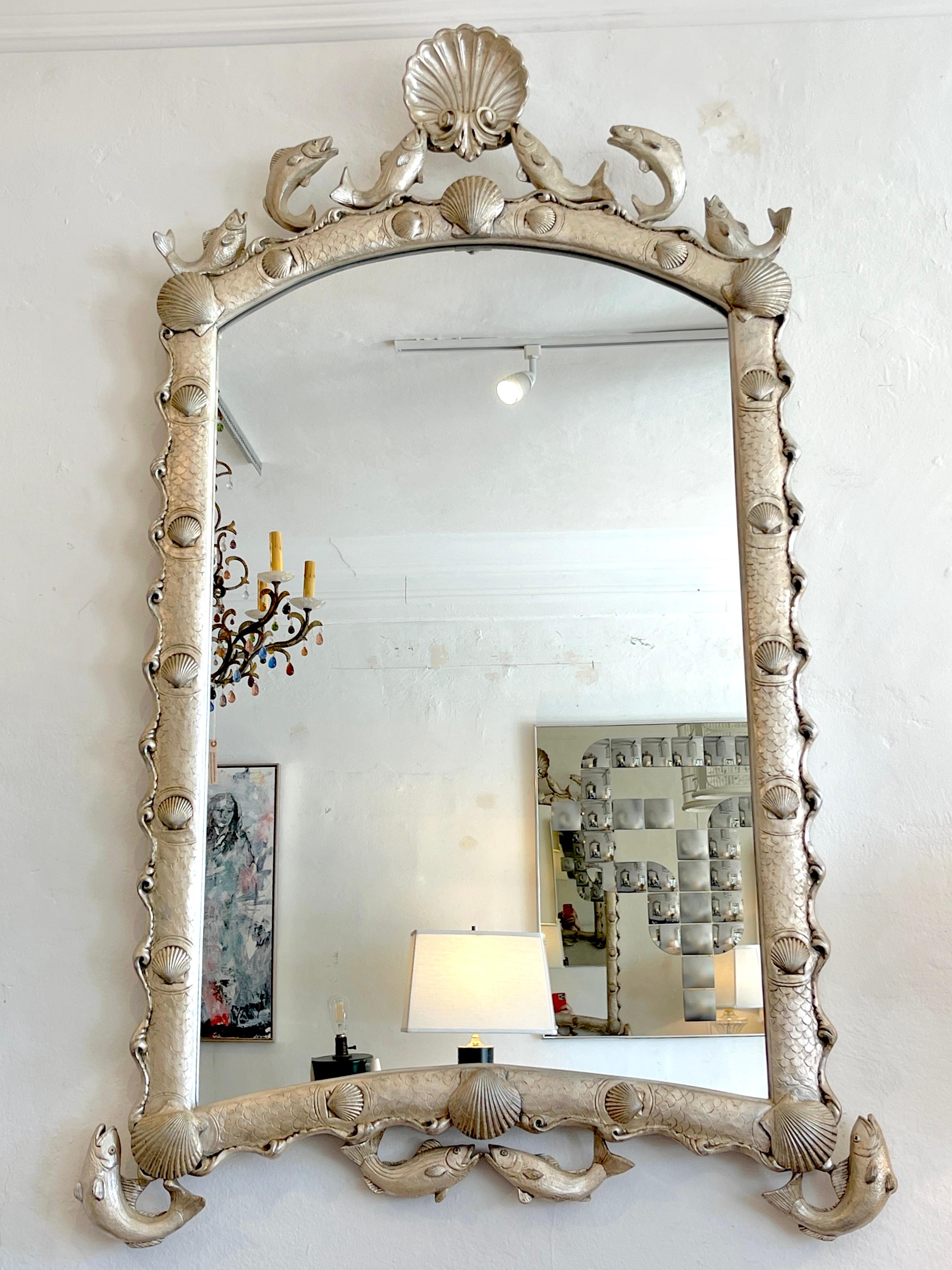 Hollywood Regency style silver-Leaf 'Martha's Vineyard' mirror by Carvers Guild 
USA, Circa 1990s

A stunning vintage example, of Martha's Vineyard' mirror by Carvers Guild silver leaf mirror The mirror decorated scalloped mirror with ocean sea