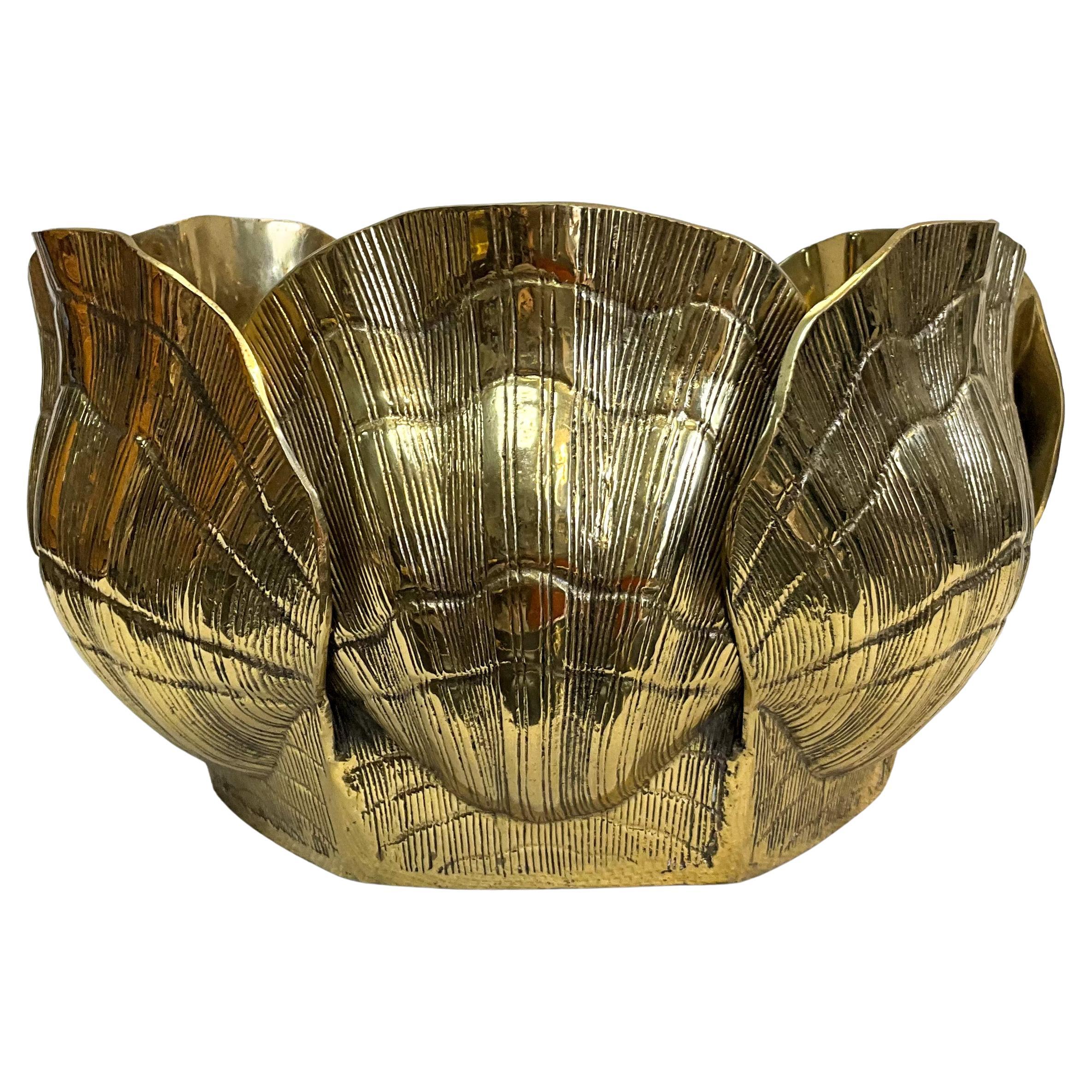 Brass brightens every room! This is a large scale Hollywood Regency style shell form planter attributed to Chapman. It is a heavy, sold brass casting. The interior has some oxidation that could possibly be scrubbed clean.