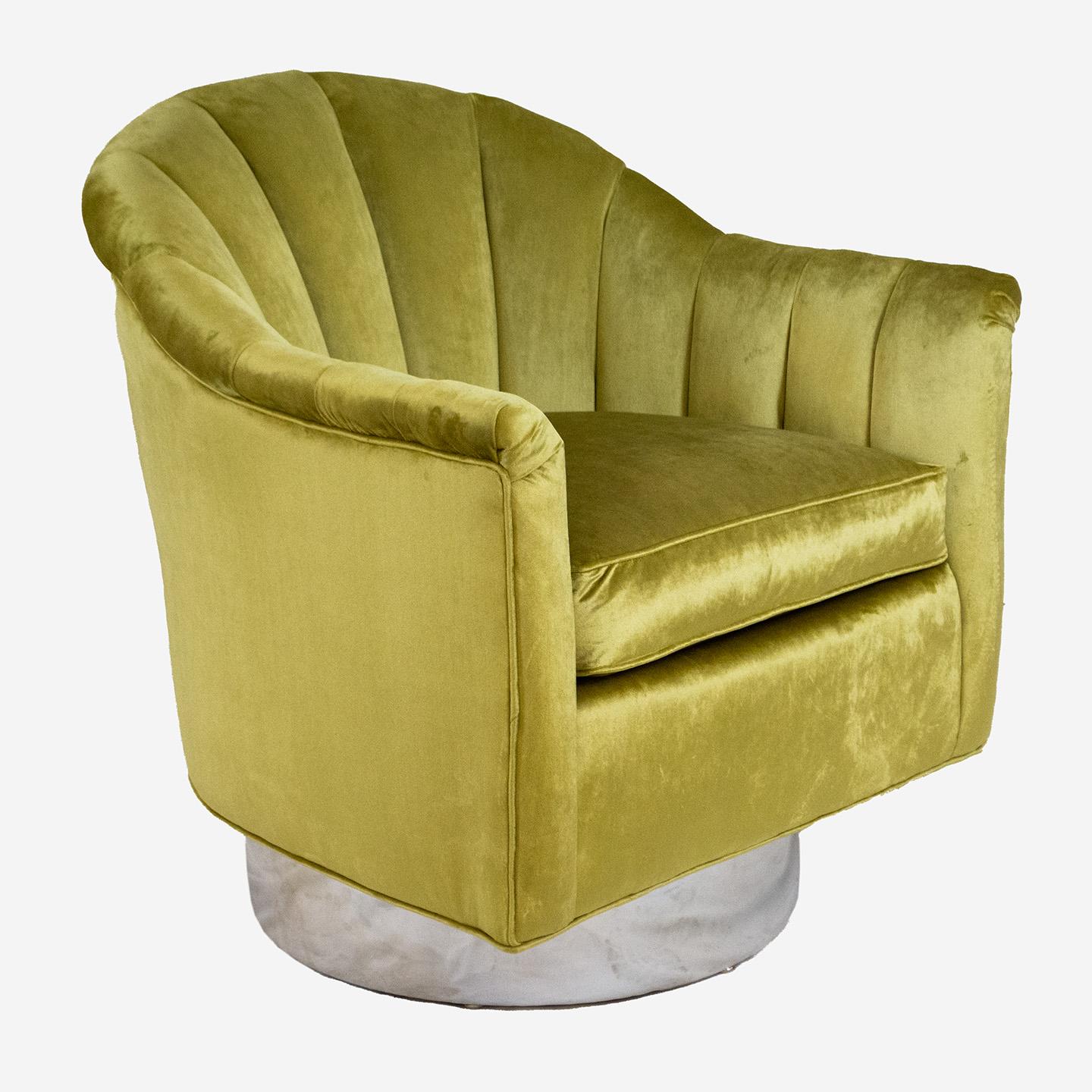 Hollywood Regency style swivel tub chair by Baker Furniture Company in citrine velvet. To add height and foster ease of getting up and down, the base has been modified with a deep swivel base and upholstered with mirror chrome fabric. Incorporated