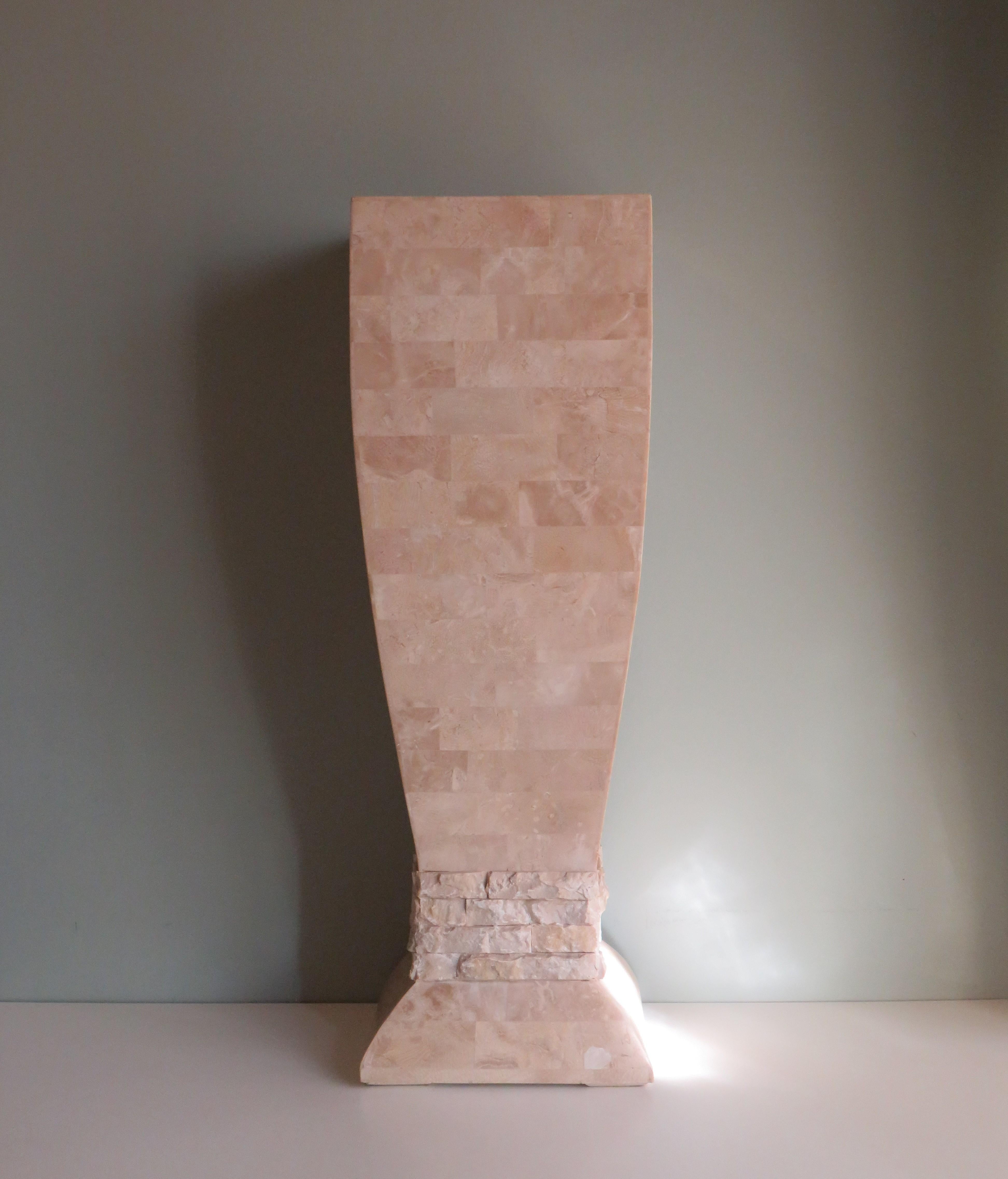 This elegantly designed column has a rougher section between the foot and the base. The column is not made of solid travertine, but of plates of travertine about 3 mm thick. The plates on the foot are mounted on a plaster base, making the column