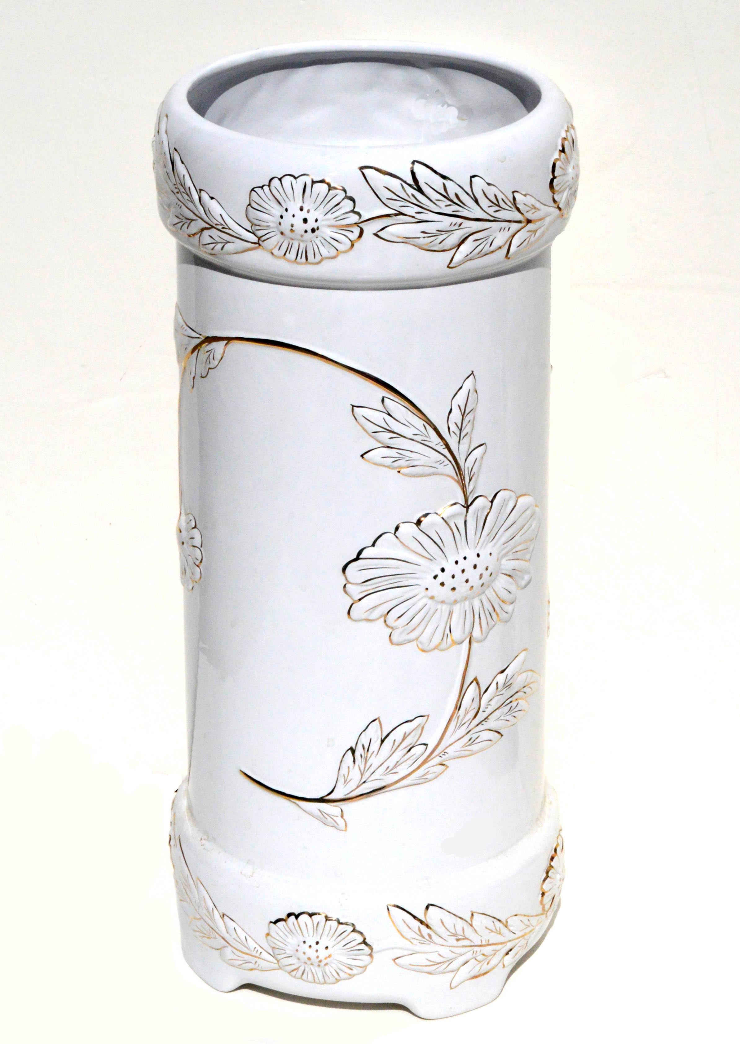 Lovely pair of white and gold Hollywood Regency style ceramic umbrella stand and jardiniere made by Alcobaca Portugal. Raised gold flowers, vines and leaves add depth and interest.

 Umbrella stand is 19
