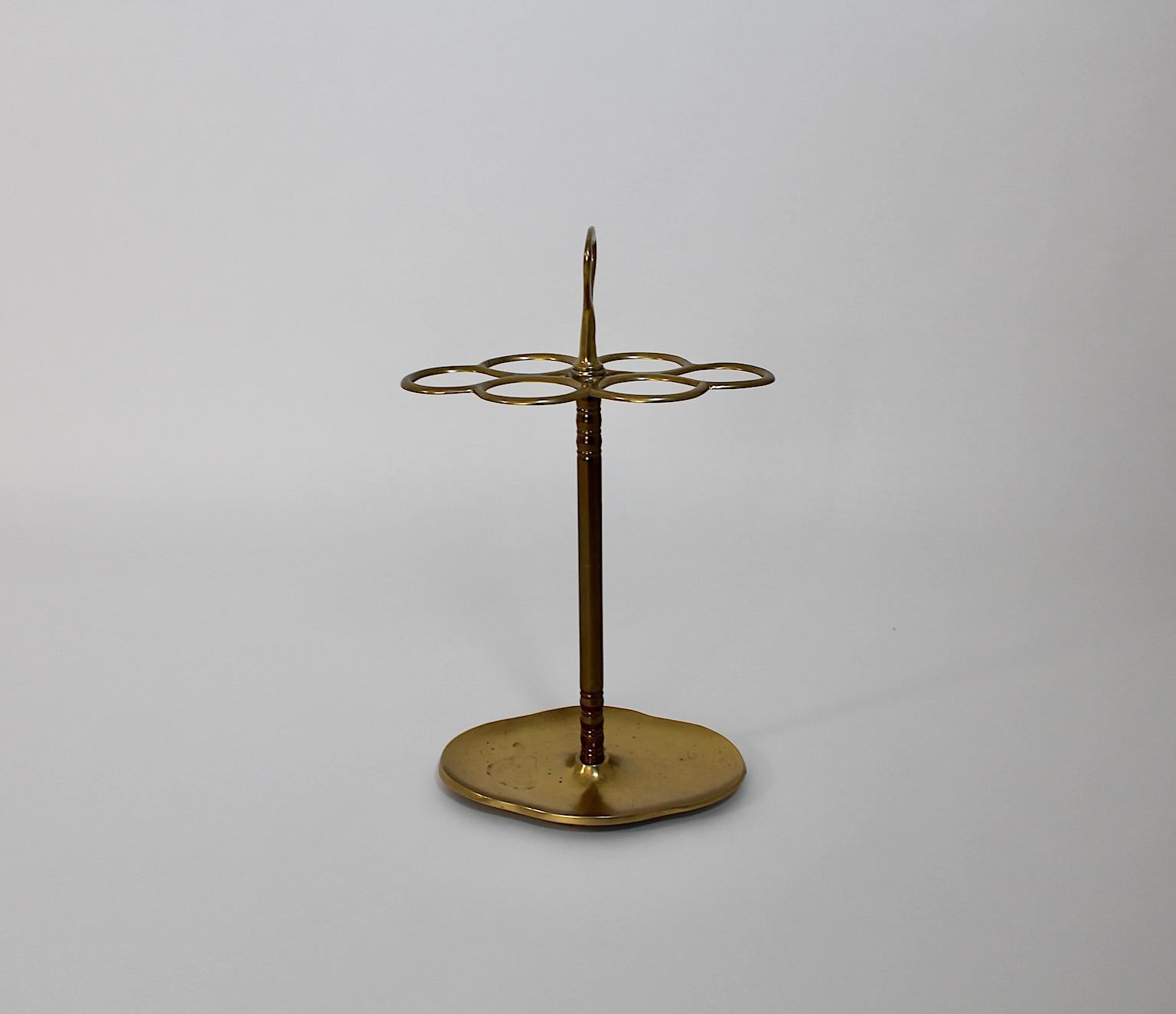 Hollywood Regency style vintage umbrella stand or cane holder from brass 1970s Italy.
A stunning umbrella stand with 6 compartments for umbrellas or canes from brass with a handle for an easy handling, While the brass body shows desirable patina and
