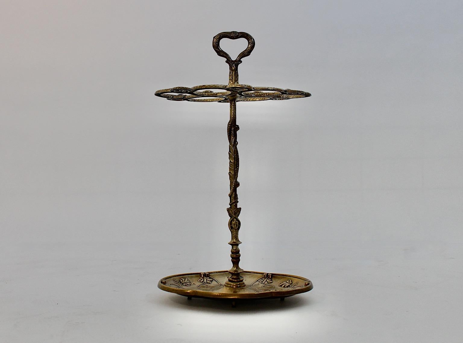 Hollywood Regency Style vintage umbrella stand from cast brass Italy, 1970s.
A wonderful vintage umbrella stand from cast brass with embossed decor as wine grapes, leaves and snakes.
This umbrella stand is characterized through beautiful patina
