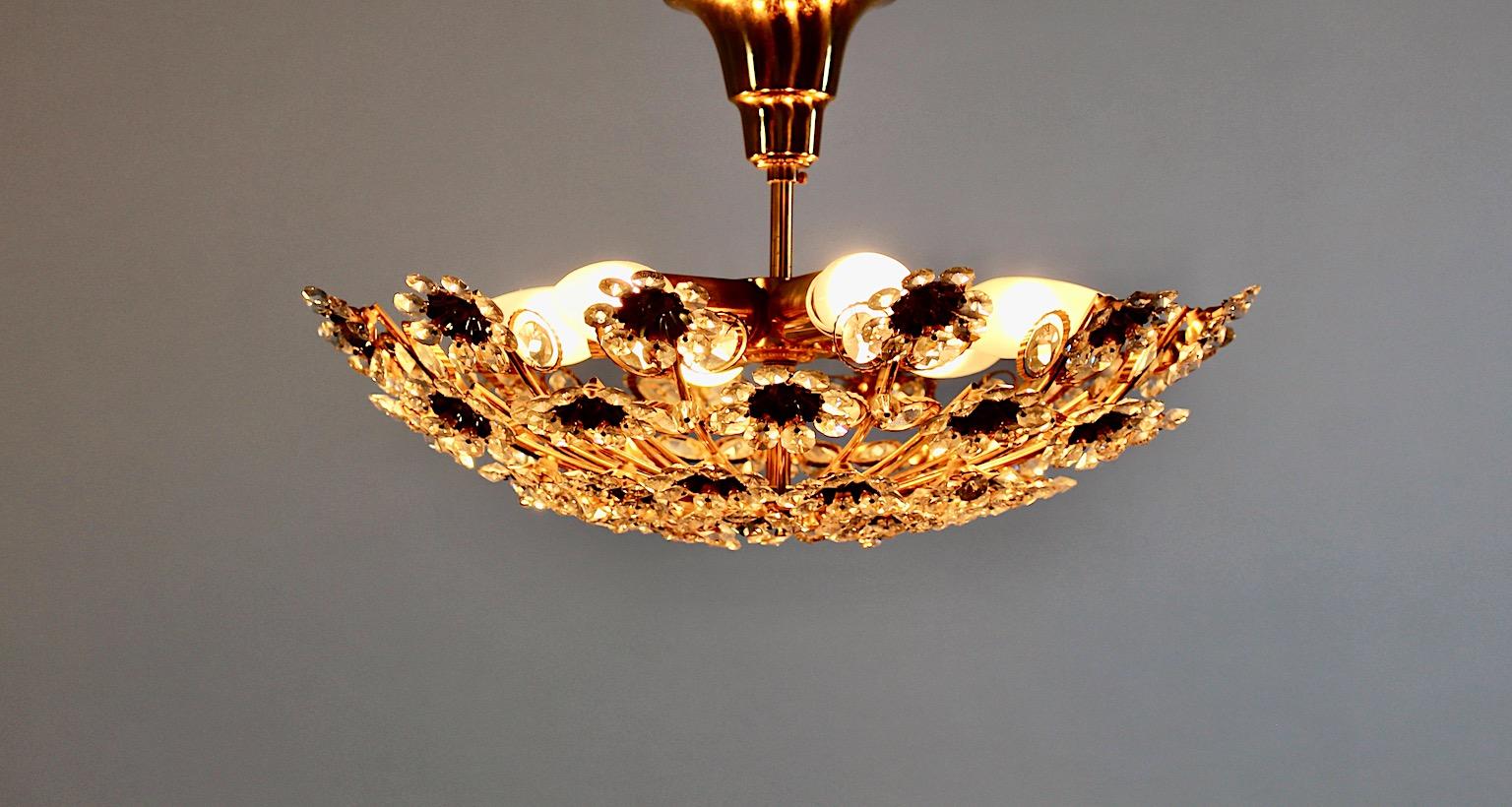 Hollywood Regency Style vintage chandelier or flush mount from gilt brass and crystal flower shape by Palwa, 1960s Germany.
An amazing chandelier or flush mount by Palwa from gilt brass and clear crystals flower like 1960s.
This chandelier needs six