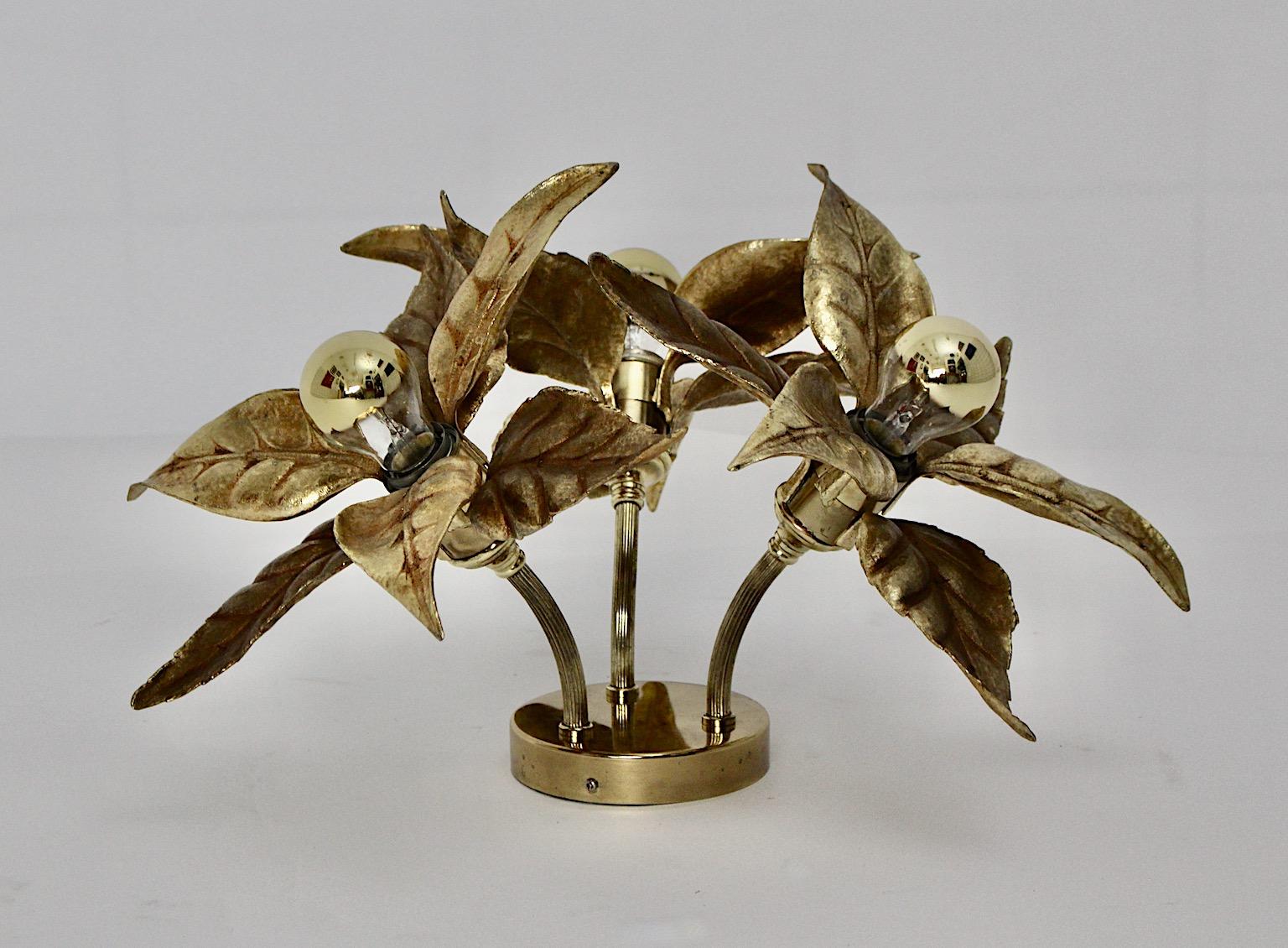Hollywood Regency style vintage floral sconce or flush mount or table lamp from golden metal flower like by Willy Daro 1970s.
Stunning vintage sconce or flush mount or table lamp with three gilt flower heads like fixed on a golden plate by Willy