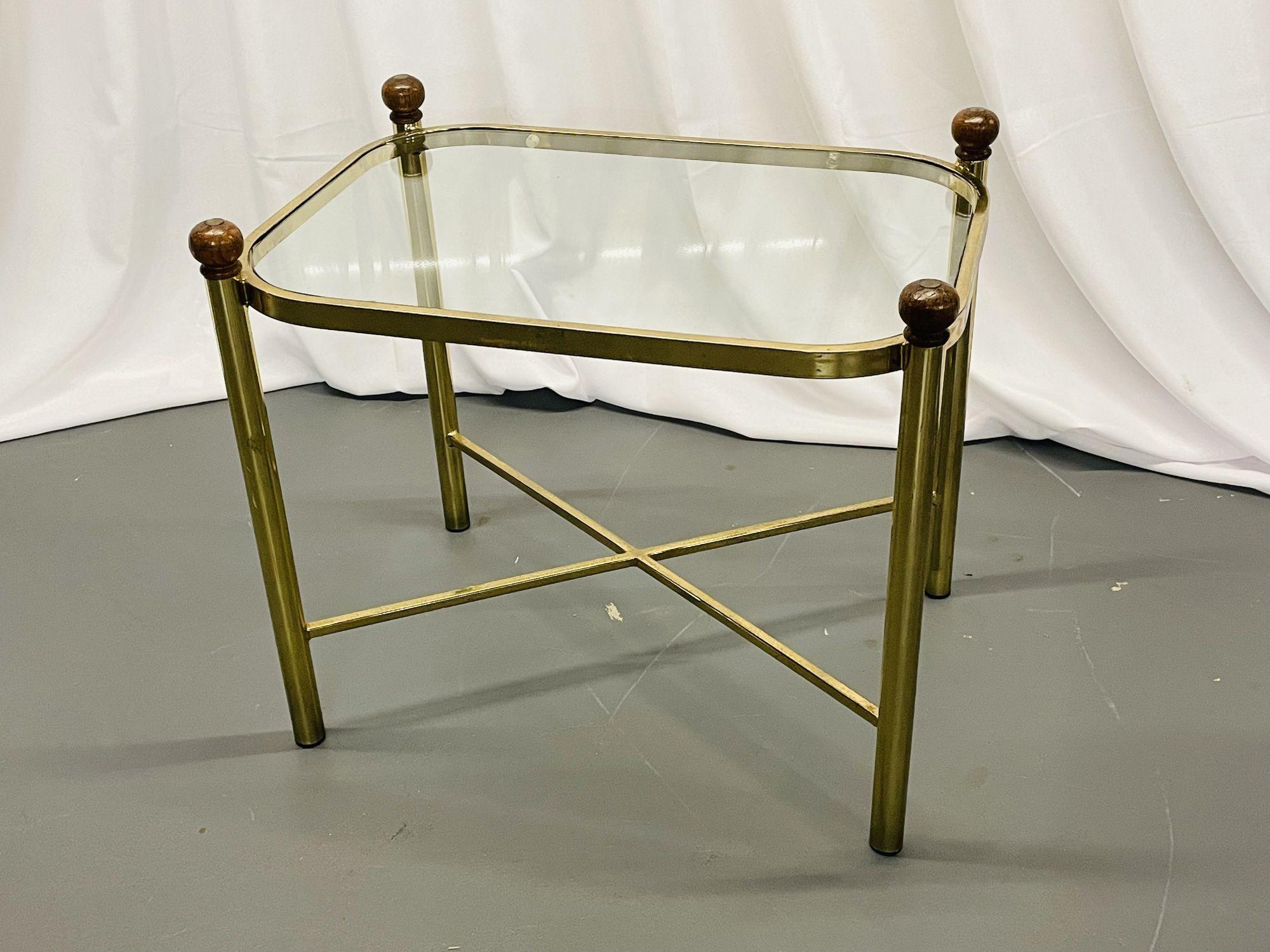 Hollywood Regency Style X-Form coffee or cocktail table, low / side / end table, Gilt Metal, Glass, Wood
 
A gilt metal and glass top mid century modern coffee or low table. The X form metal base supporting a glass top terminating in four barrel
