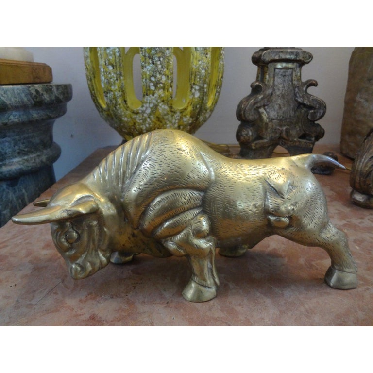 Well Cast mid-century cast brass bull figure or statue. This beautifully detailed Hollywood Regency stylized brass bull sculpture would look great on a tabletop or in a bookcase.
