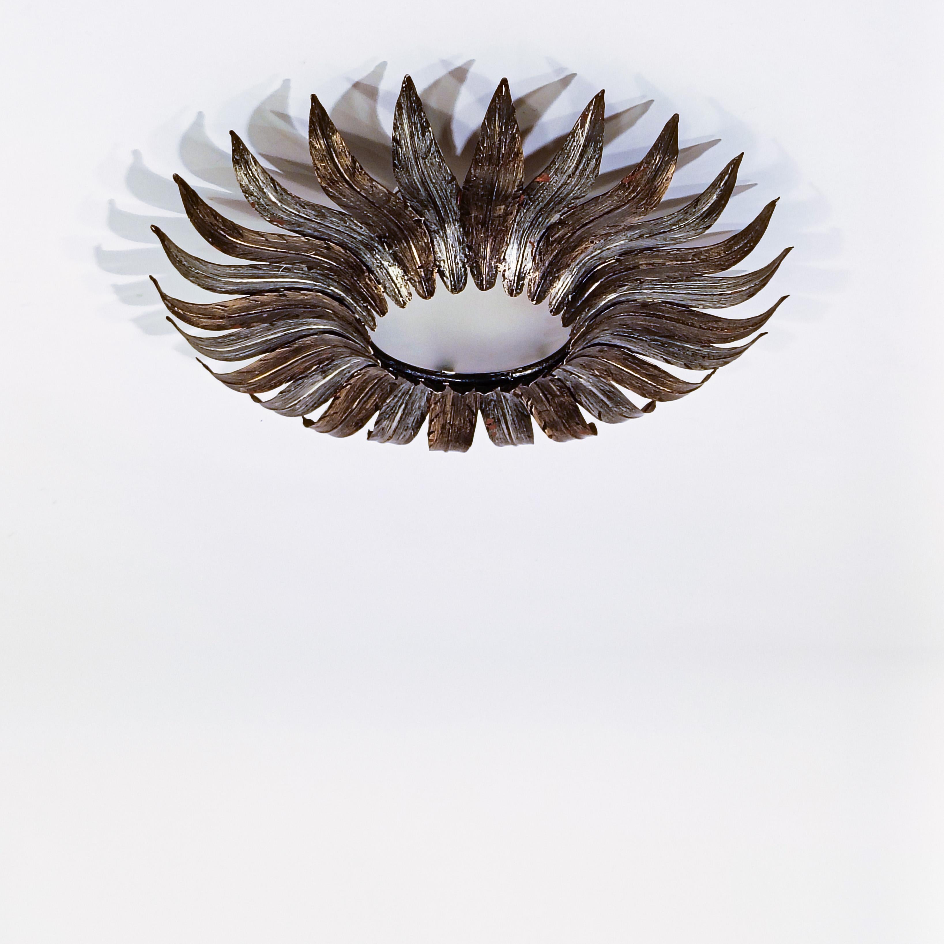 Montaje empotrado con hojas de sol estilo Hollywood Regency de Ferro Art (también conocido como Ferroarte), España, años 50. Estructura metálica formada por una base circular de hierro forjado donde se sueldan diferentes hojas o rayos de sol en