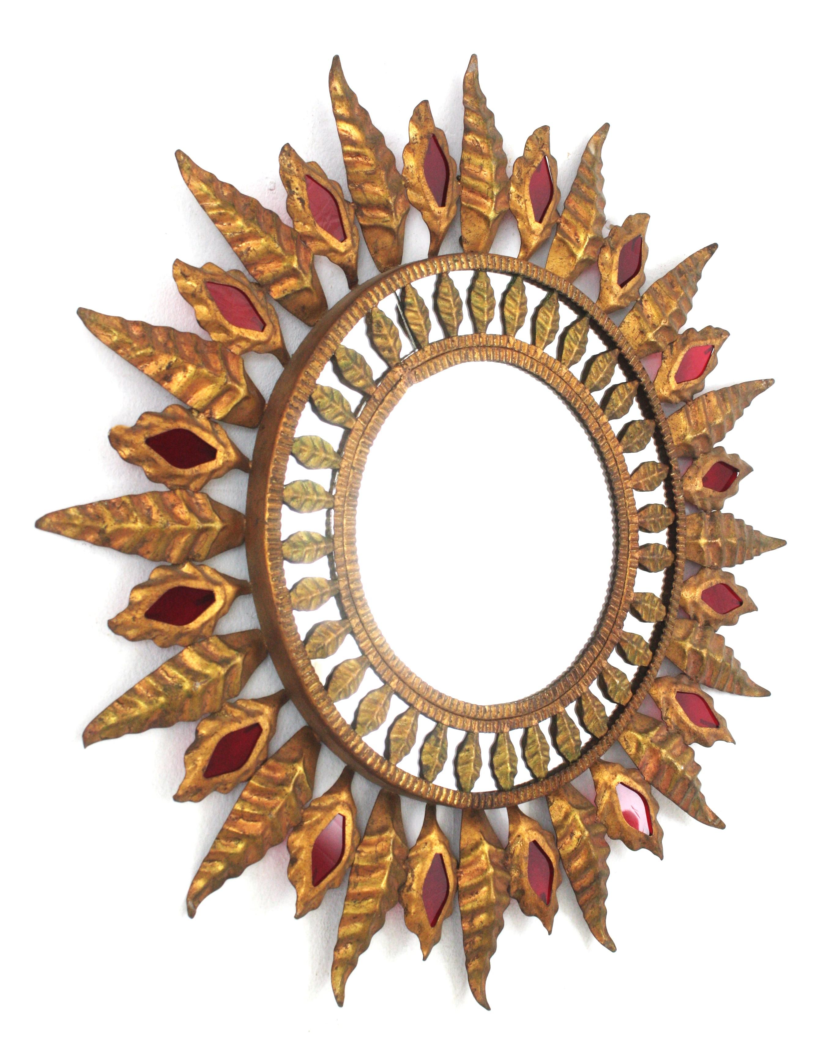 Mid-Century Modern Hollywood Regency Sunburst Mirror in Gilt Metal and Red Glass Detail, 1950s For Sale