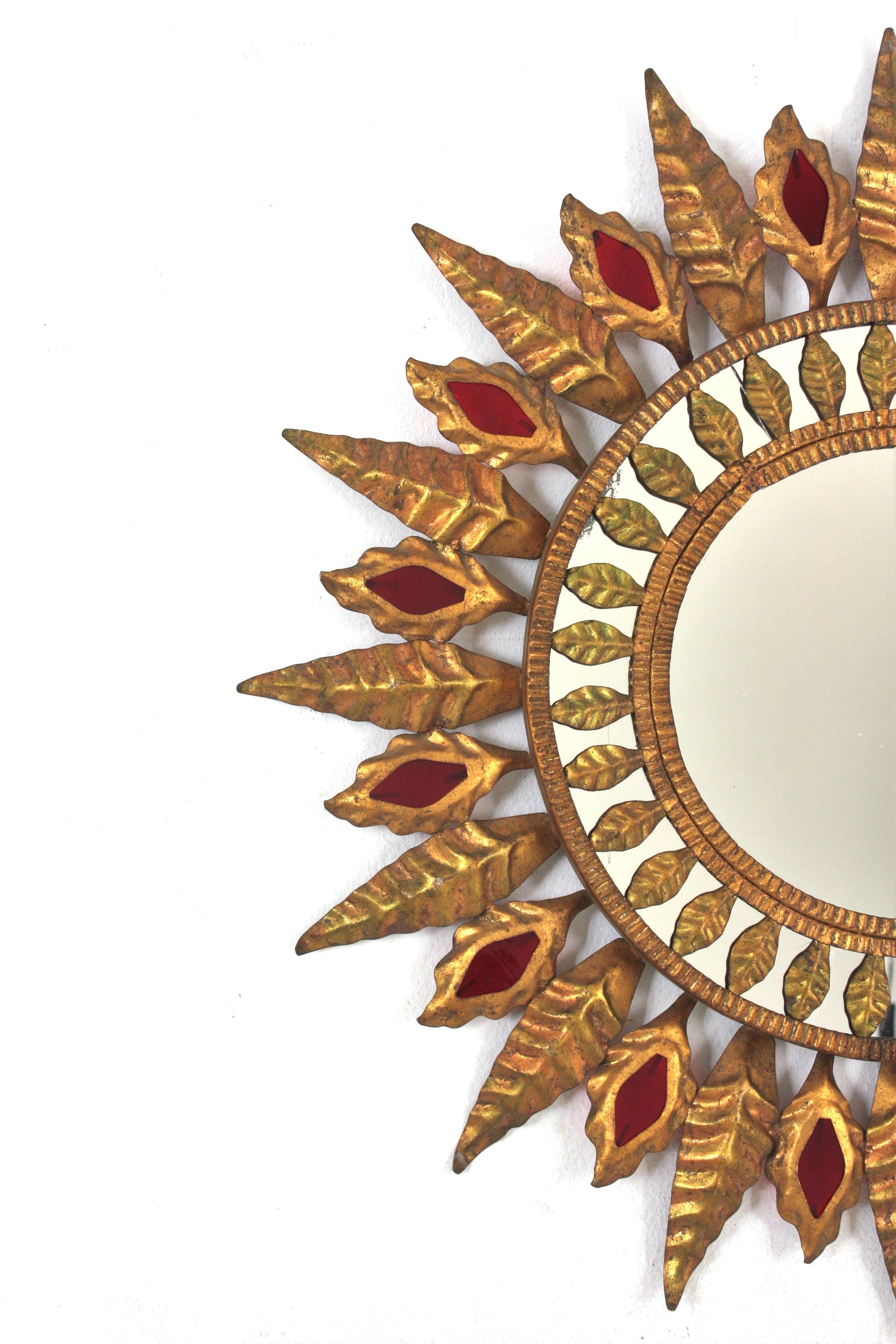 20th Century Hollywood Regency Sunburst Mirror in Gilt Metal and Red Glass Detail, 1950s For Sale