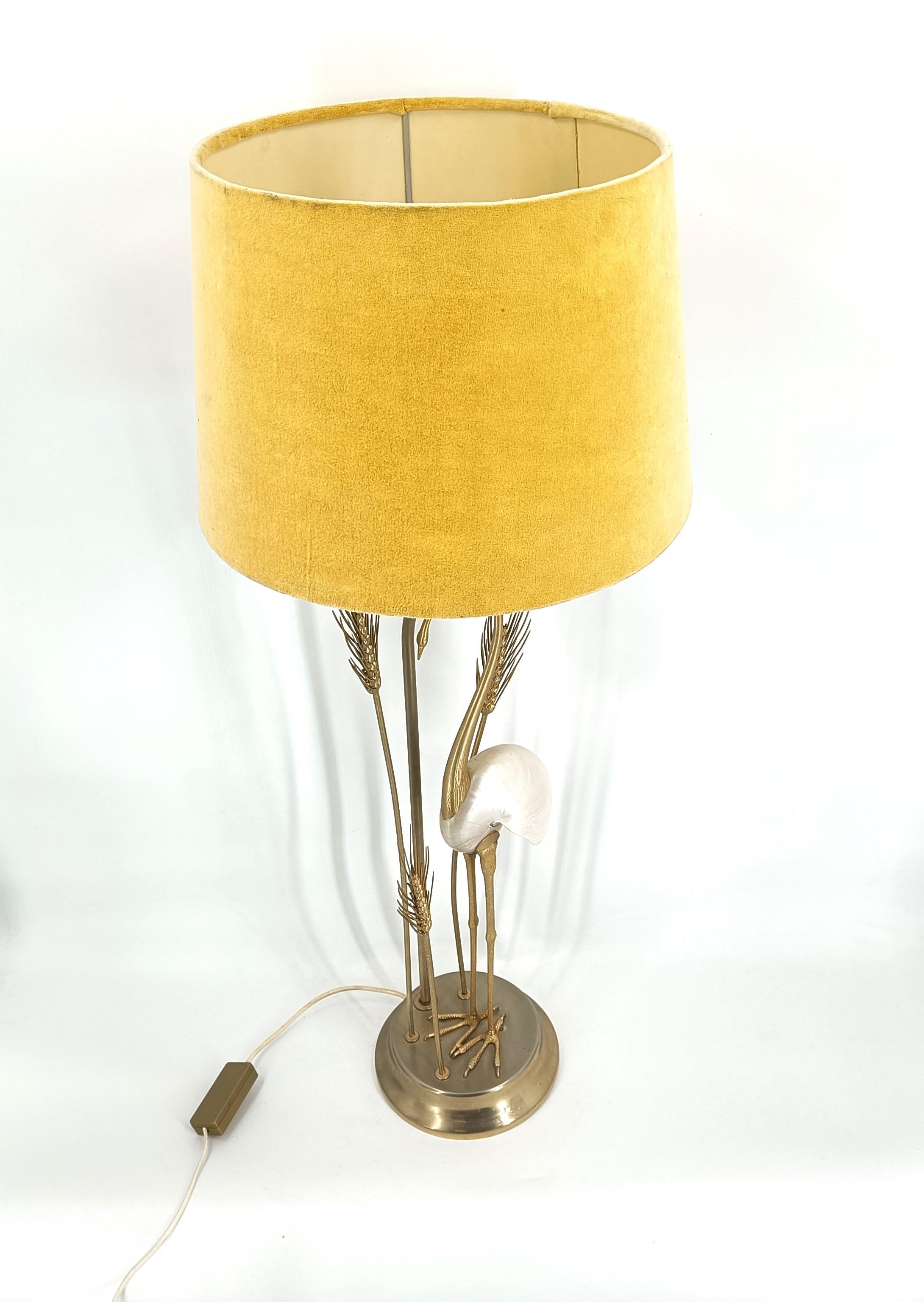 Mid century art table lamp crafted by Antonio Pavia, consisting of a ceramic foot, sculpted brass crane bird and water plants and a velvet shade. The center piece of this lamp is ofcourse the mother of pearl nautilus.

Fantastic statement