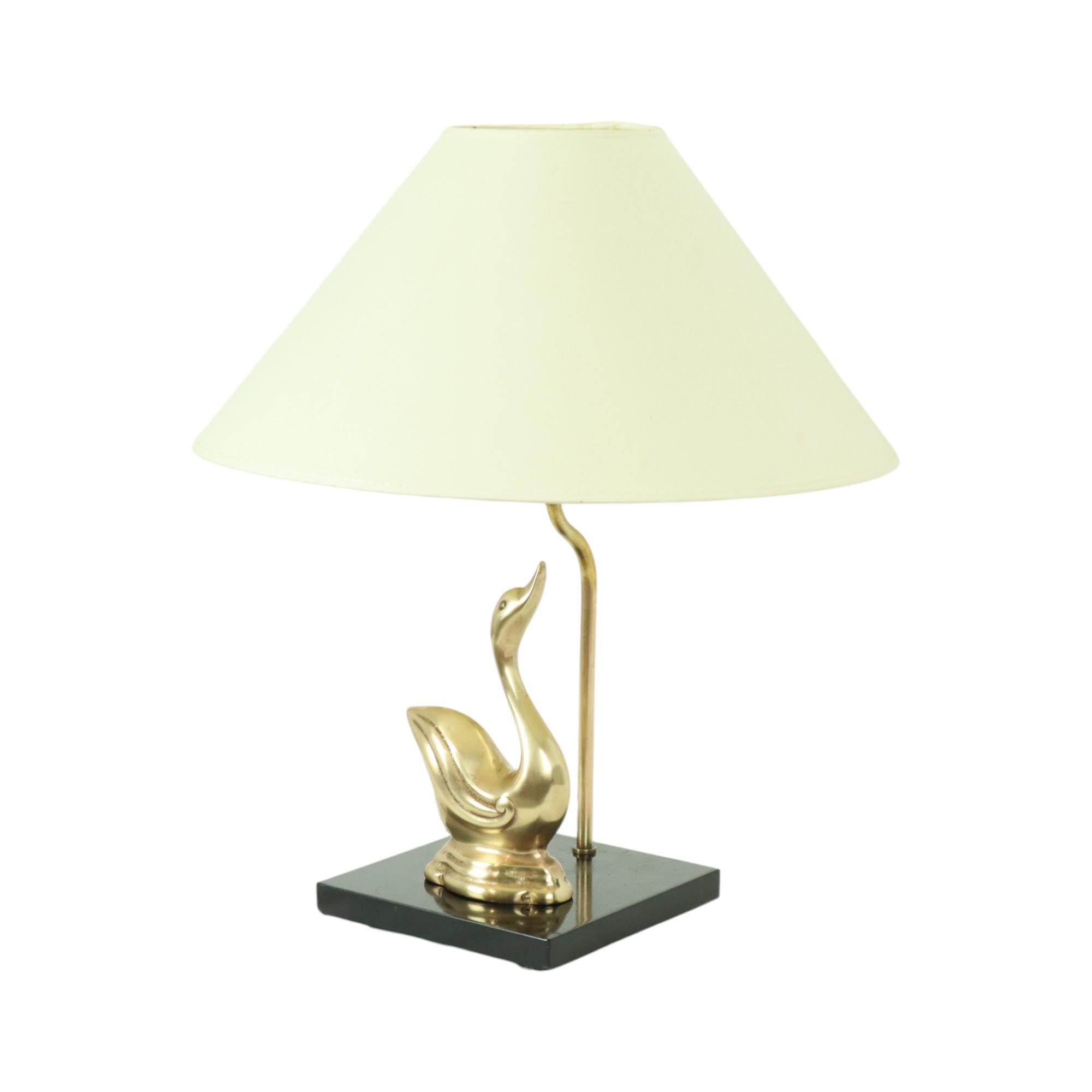 Hollywood Regency style table lamp in the shape of a graceful swan, on a black wooden base, with a white lampshade, by Regina and Massive, Belgium, 1960s-70s.

This fantastically beautiful, high-quality lamp has a timeless design, completely in the