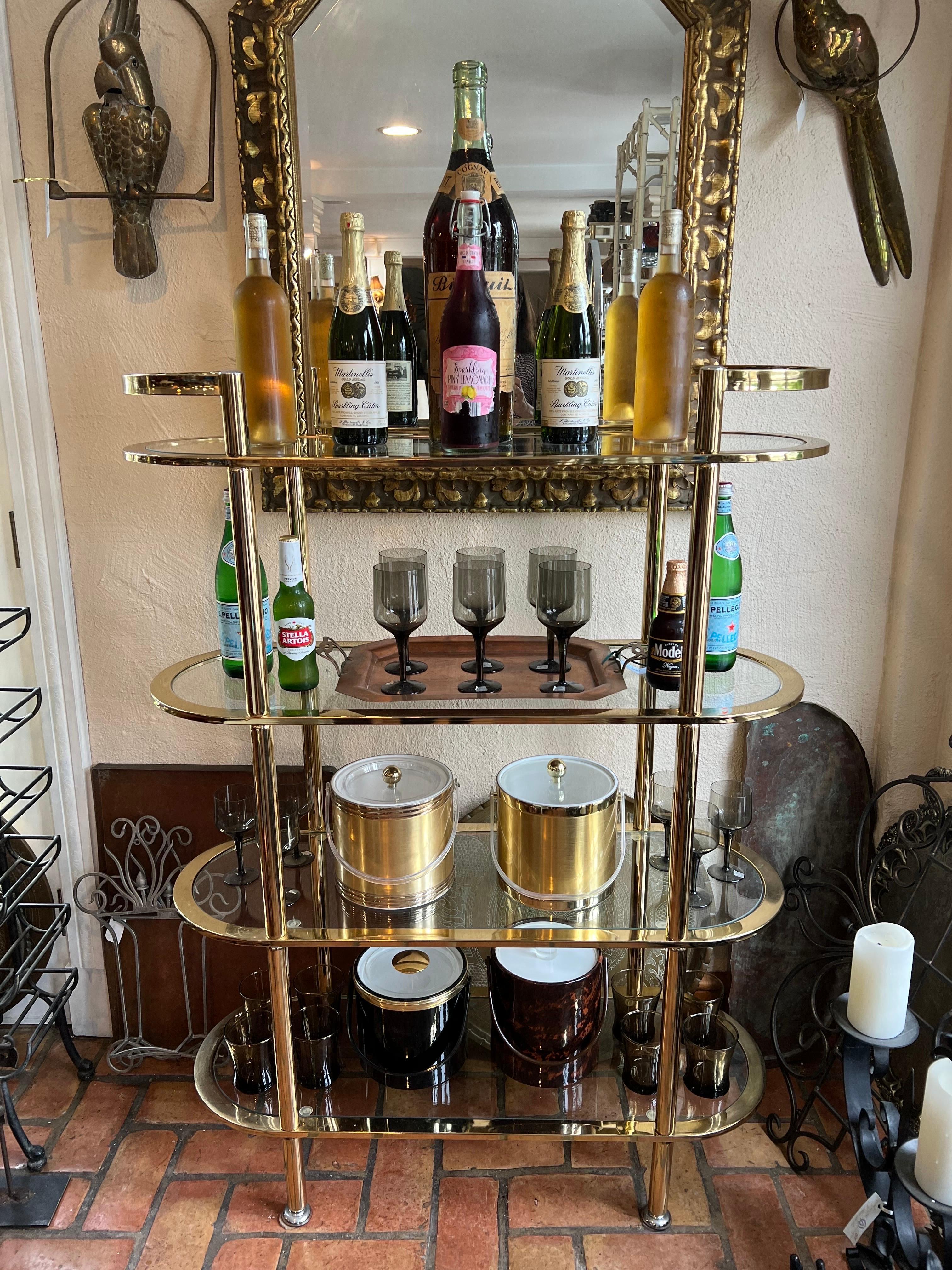 Hollywood Regency tall tiered bar cart/etagere. A stunning brass and glass four tiered bar cart that could also function as a mid size etagere. Chrome accents on feet and handle tops. Versatile, stylish and a beautiful addition to any home. Could