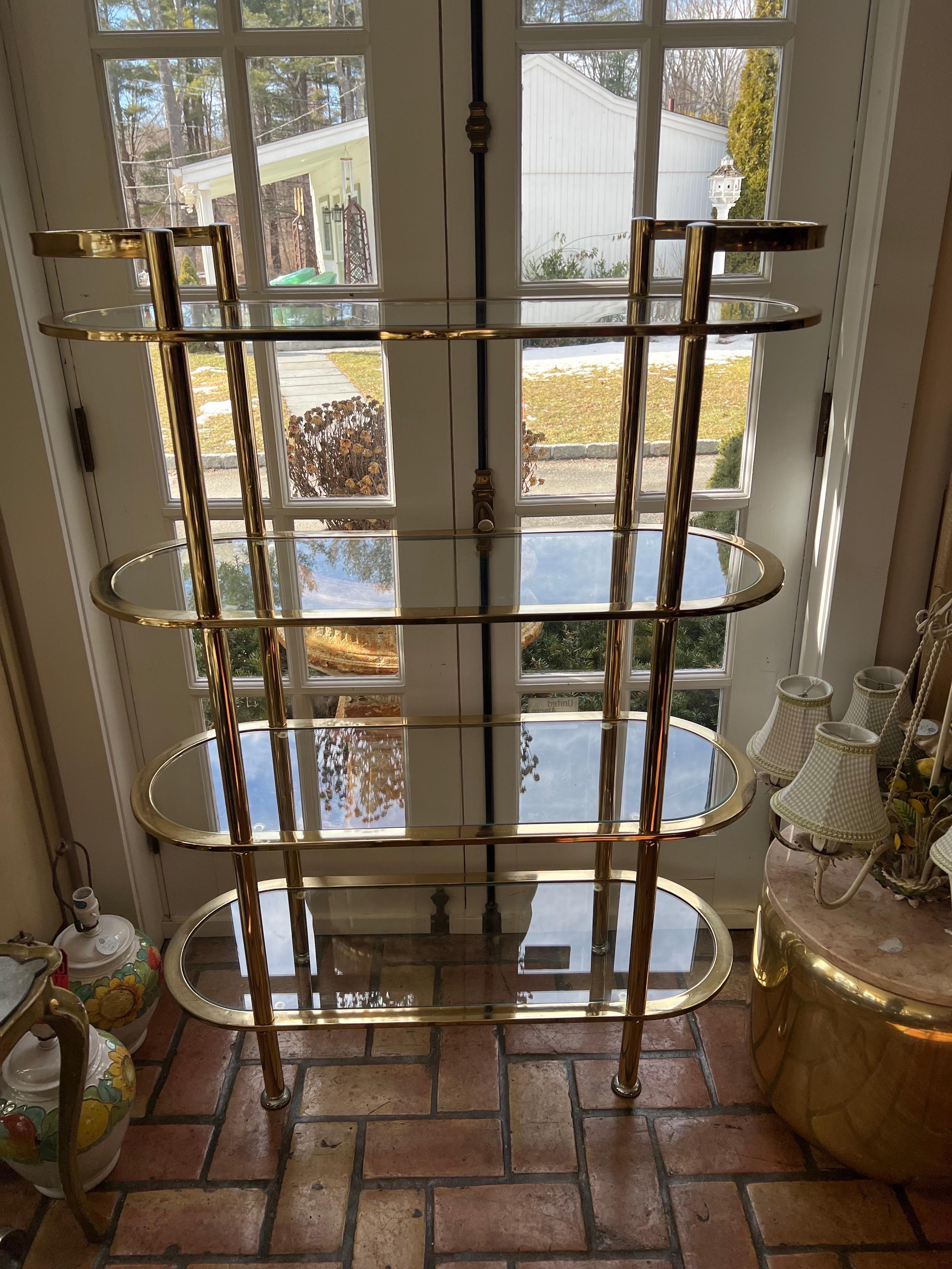 Hollywood Regency tall tiered bar cart / Etagere. A stunning brass and glass four tiered bar cart that could also function as a mid size etagere. Versatile, stylish and a beautiful addition to any home. Could also be used in a dressing closet for